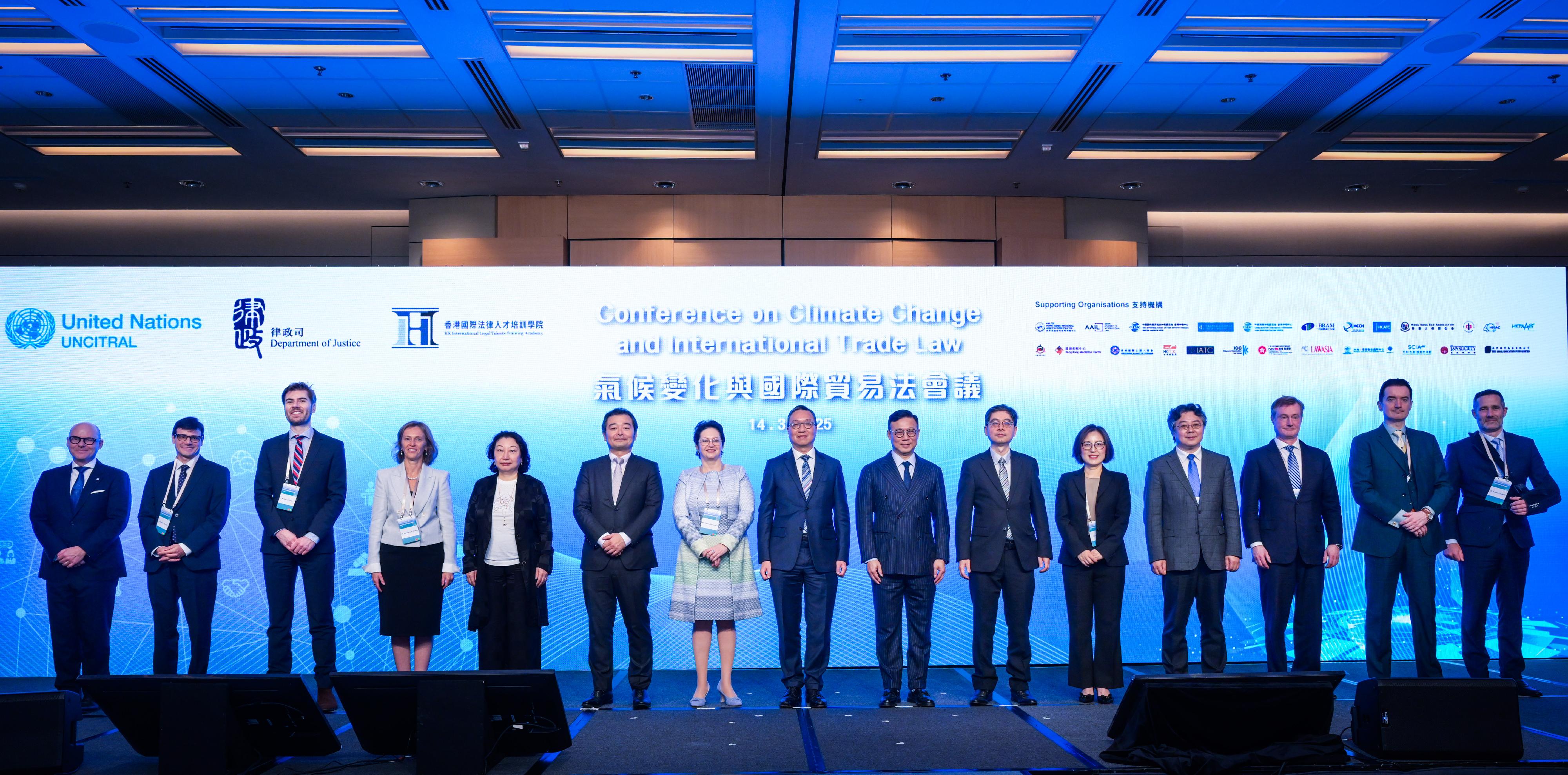 The Conference on Climate Change and International Trade Law was held in hybrid format in Hong Kong today (March 14). Photo shows the Secretary for Justice, Mr Paul Lam, SC (centre); the Deputy Secretary for Justice, Dr Cheung Kwok-kwan (seventh right); the Law Officer (International Law) of the Department of Justice (DoJ), Dr James Ding (sixth right); the Director of the Hong Kong International Legal Talents Training Office of the DoJ, Dr Yang Ling (fifth right), and other speakers at the conference.