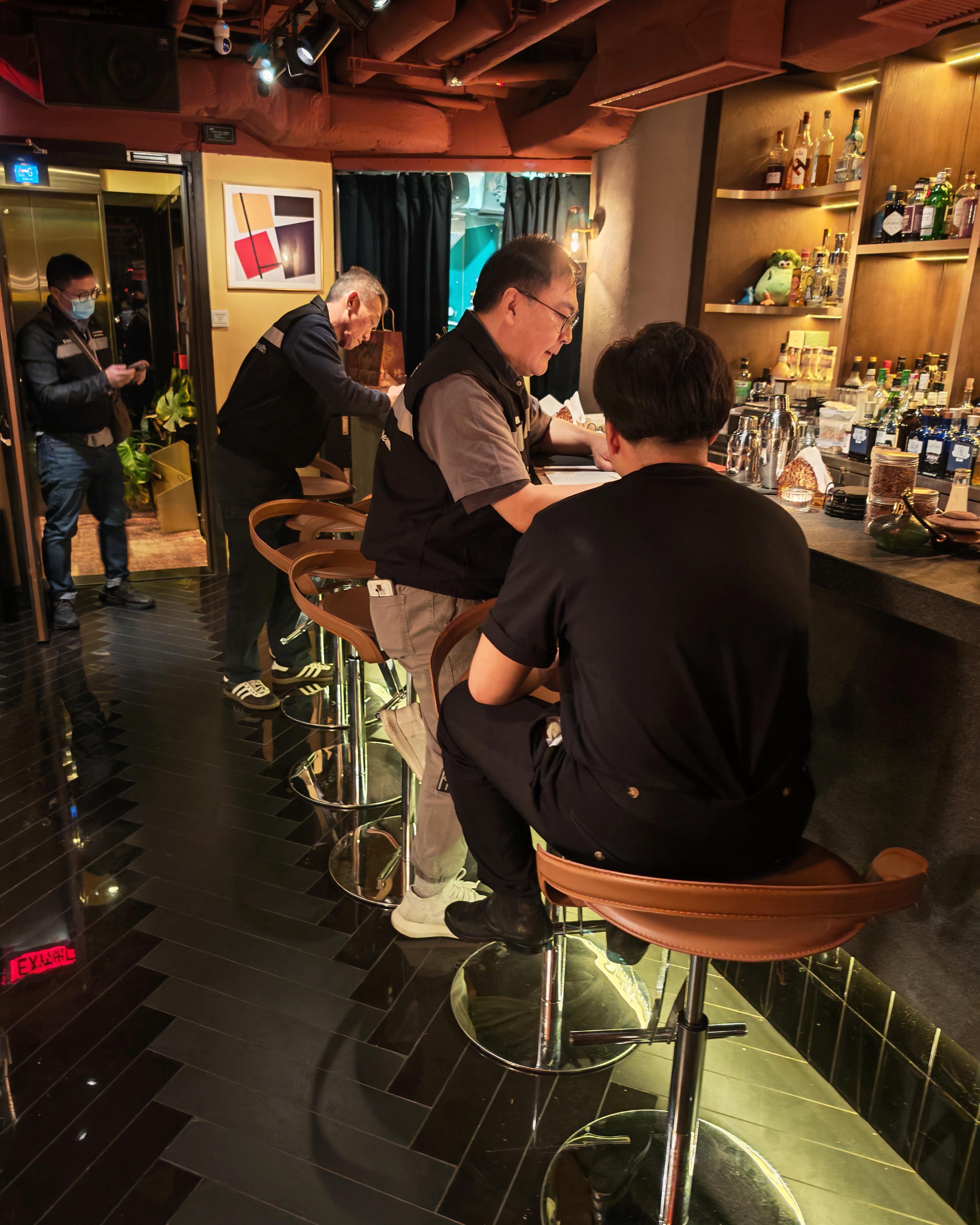 The Tobacco and Alcohol Control Office (TACO) of the Department of Health continued to clamp down on illegal waterpipe smoking in no smoking areas by conducting another enforcement operation, codenamed "Pipepurge", in Central last night (March 14) and issued a total of two fixed penalty notices. Photo shows TACO officers taking enforcement action inside a bar.