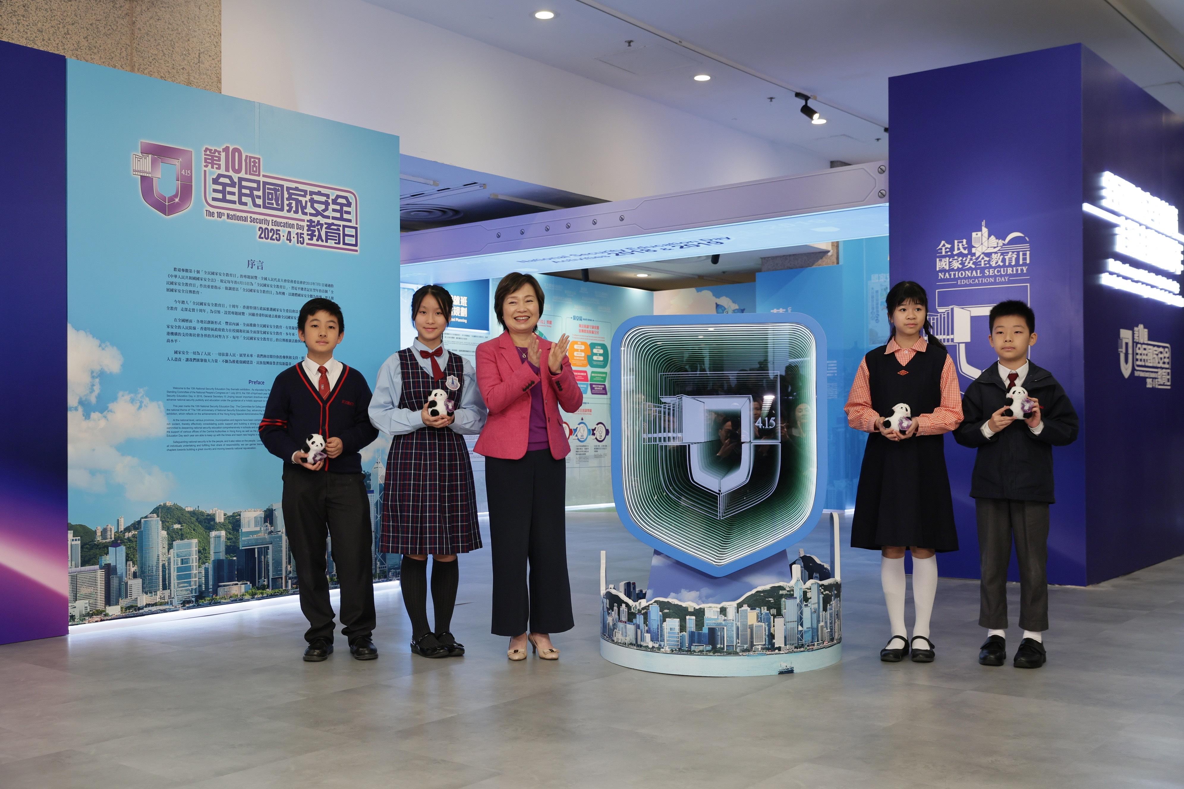 The Secretary for Education, Dr Choi Yuk-lin (centre), and student representatives attend the opening ceremony of the 10th National Security Education Day thematic exhibition today (March 18).