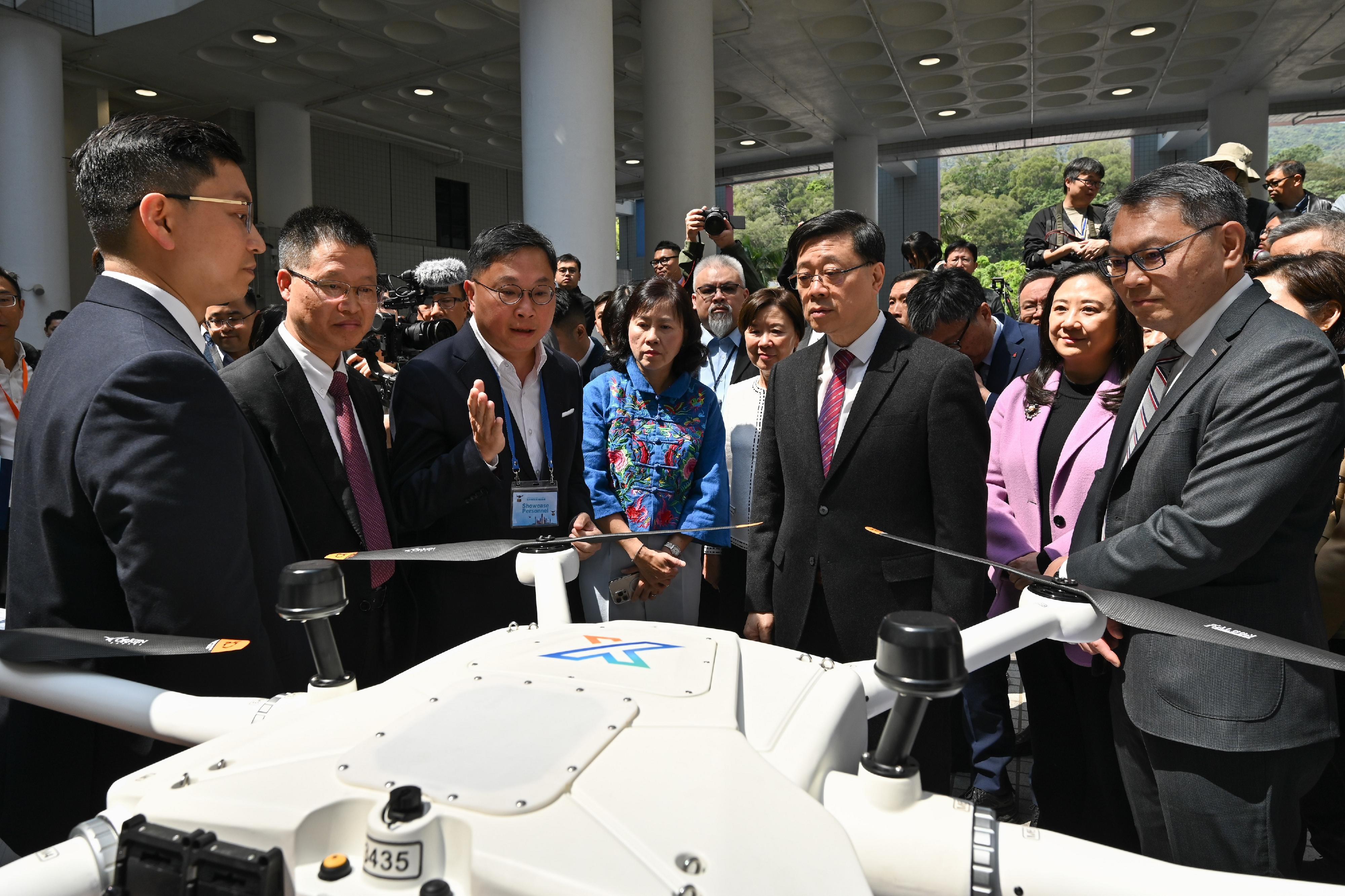 The Chief Executive, Mr John Lee, attended the Low-altitude Economy Regulatory Sandbox - Launch Event today (March 20). Photo shows Mr Lee (second right); the Secretary for Transport and Logistics, Ms Mable Chan (fourth left); the Director-General of Civil Aviation, Mr Victor Liu (first right), and other guests touring the booths.