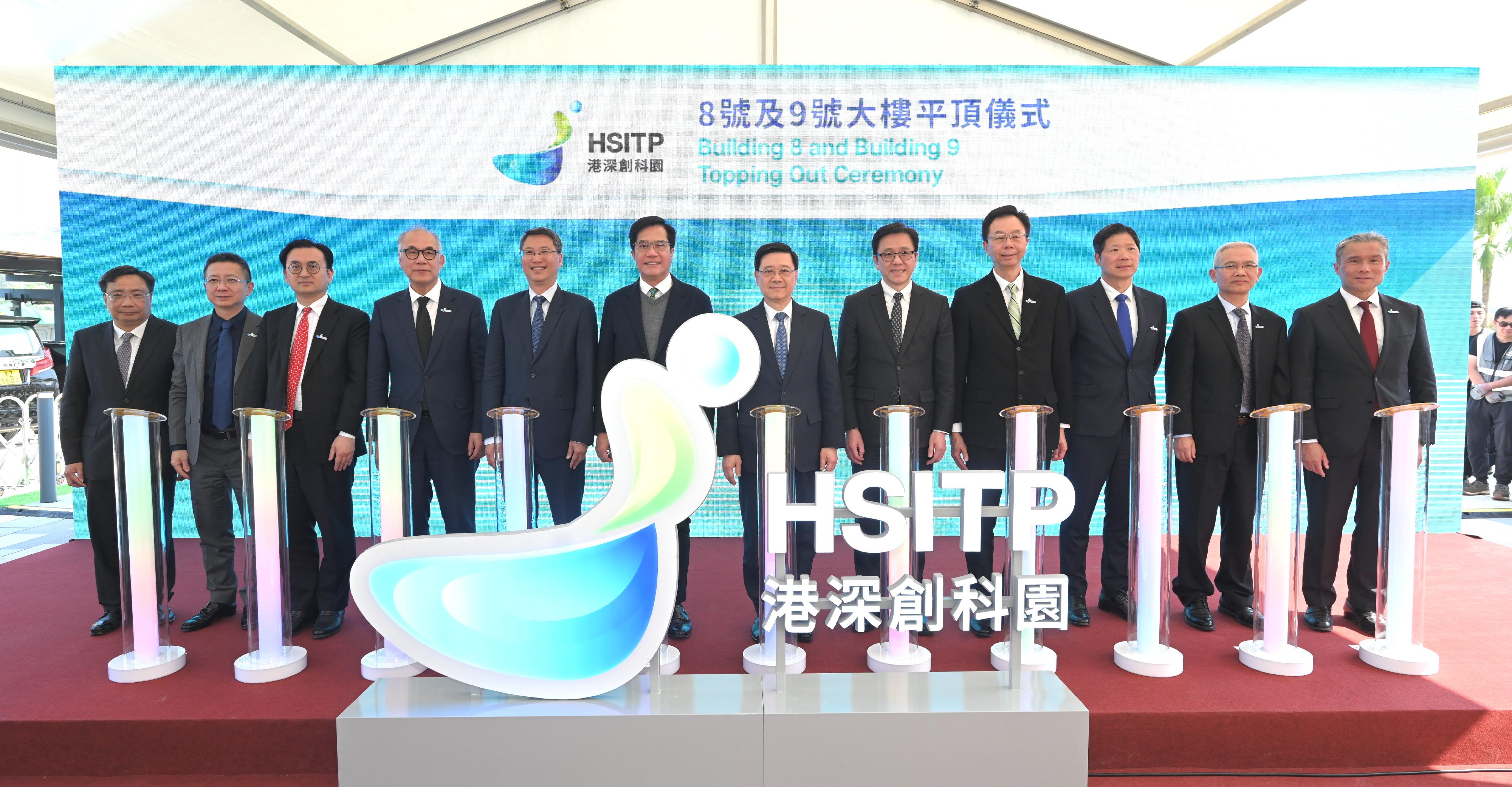 The Chief Executive, Mr John Lee, attended the Hong Kong-Shenzhen Innovation and Technology Park Building 8 and Building 9 Topping Out Ceremony today (March 21). Photo shows (from fifth left) the Permanent Secretary for Innovation, Technology and Industry and Chairman of the Hong Kong-Shenzhen Innovation and Technology Park Limited, Mr Eddie Mak; the Acting Financial Secretary, Mr Michael Wong; Mr Lee; the Secretary for Innovation, Technology and Industry, Professor Sun Dong, and other guests officiating at the lighting ceremony.