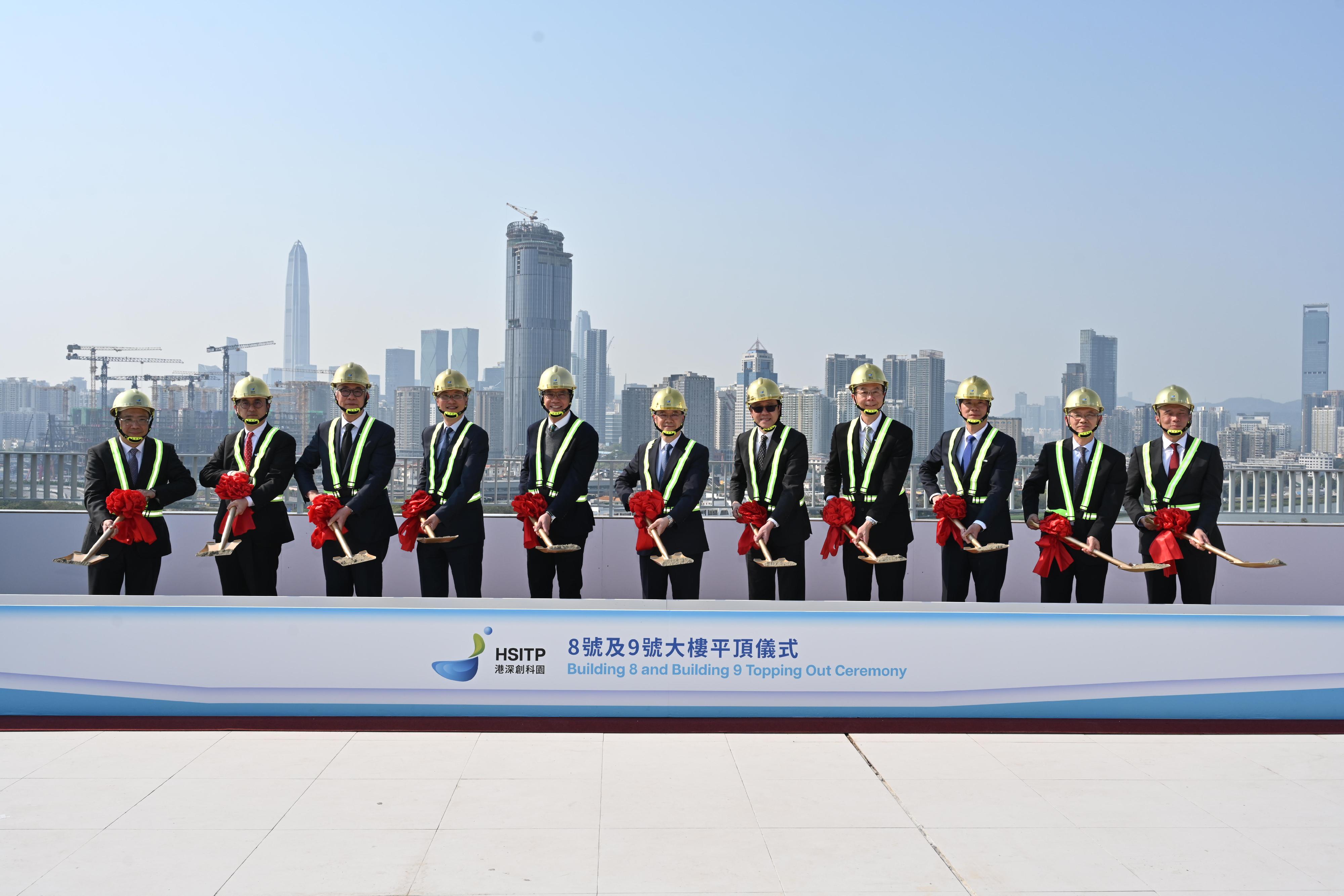 The Chief Executive, Mr John Lee, attended the Hong Kong-Shenzhen Innovation and Technology Park Building 8 and Building 9 Topping Out Ceremony today (March 21). Photo shows (from fourth left) the Permanent Secretary for Innovation, Technology and Industry and Chairman of the Hong Kong-Shenzhen Innovation and Technology Park Limited, Mr Eddie Mak; the Acting Financial Secretary, Mr Michael Wong; Mr Lee; the Secretary for Innovation, Technology and Industry, Professor Sun Dong, and other guests at the topping out ceremony.