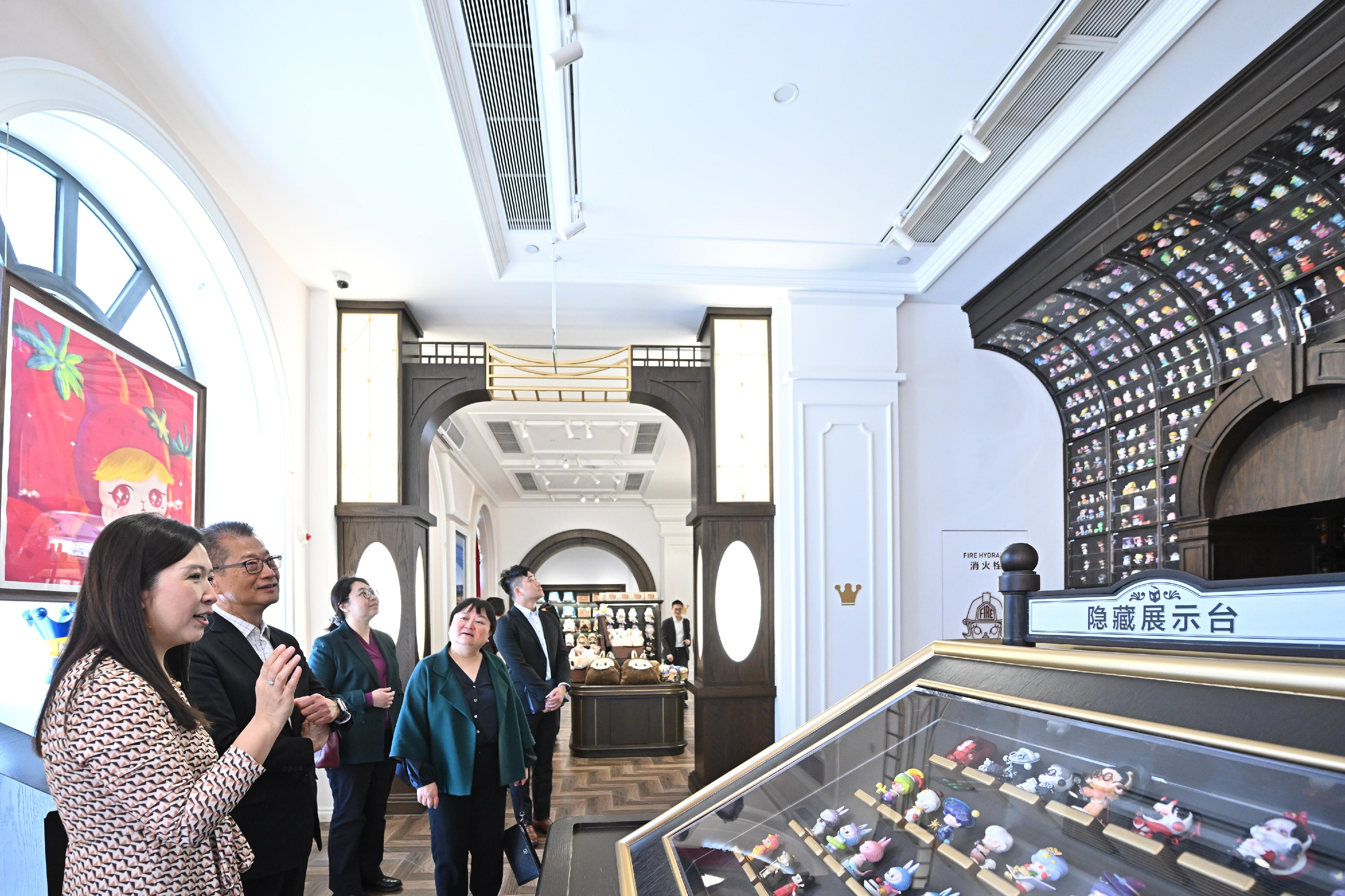 The Financial Secretary, Mr Paul Chan, who is currently visiting Beijing, visited a number of companies today (March 22). Photo shows Mr Chan (second left) visiting a leading pop cultural entertainment company on the Mainland and viewing its product displays.