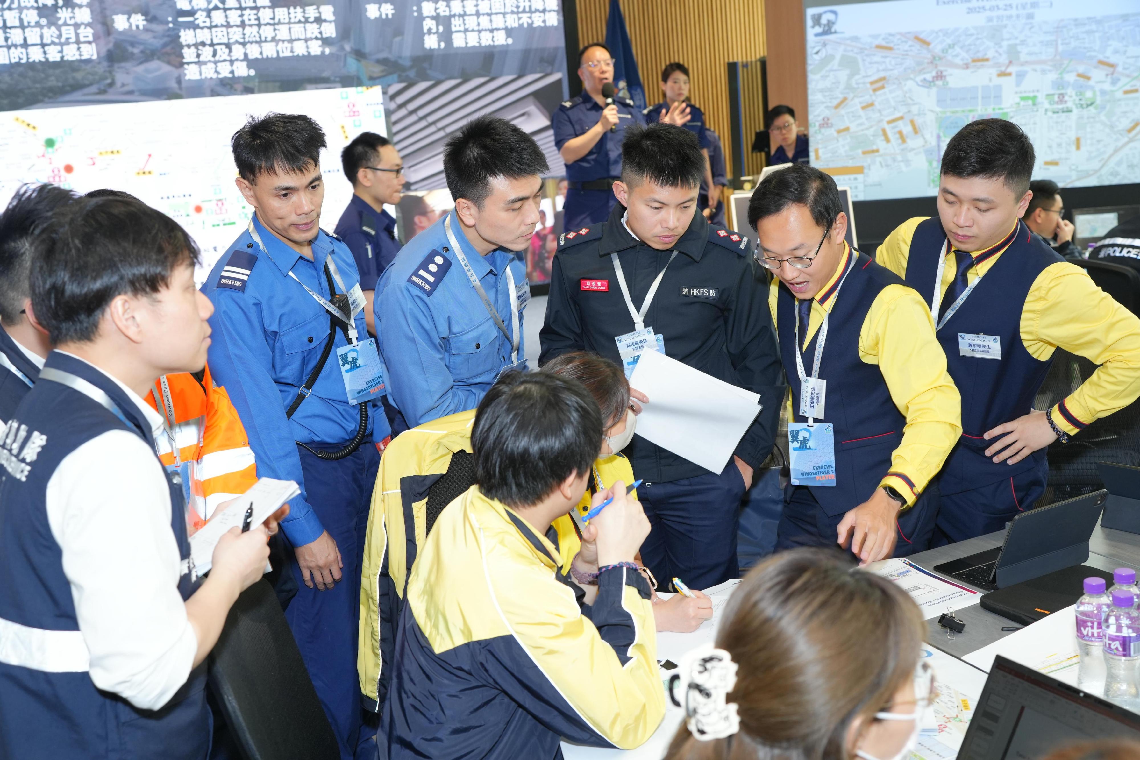 The Kowloon East Region of the Hong Kong Police Force (HKPF)conducted the second phase inter-departmental tabletop exercise for the Kai Tak Sports Park at the Kowloon East Regional Headquarters today (March 25). Photo shows representatives from relevant government departments and organisations discussing contingency measures for potential emergency situations.
