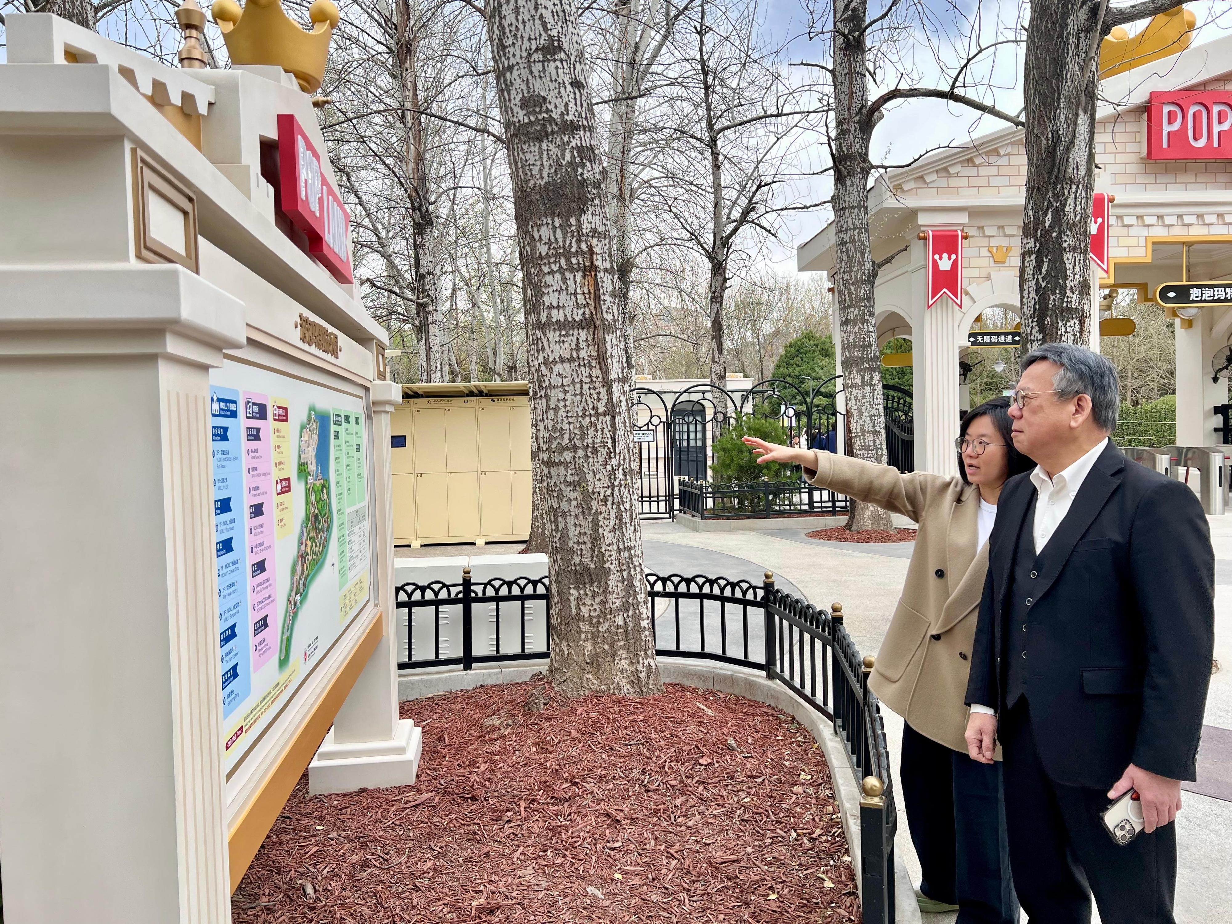 The Secretary for Commerce and Economic Development, Mr Algernon Yau, continued his visit to Beijing today (March 28). Photo shows Mr Yau (right) visiting a renowned pop cultural entertainment company on the Mainland and touring its thematic park.