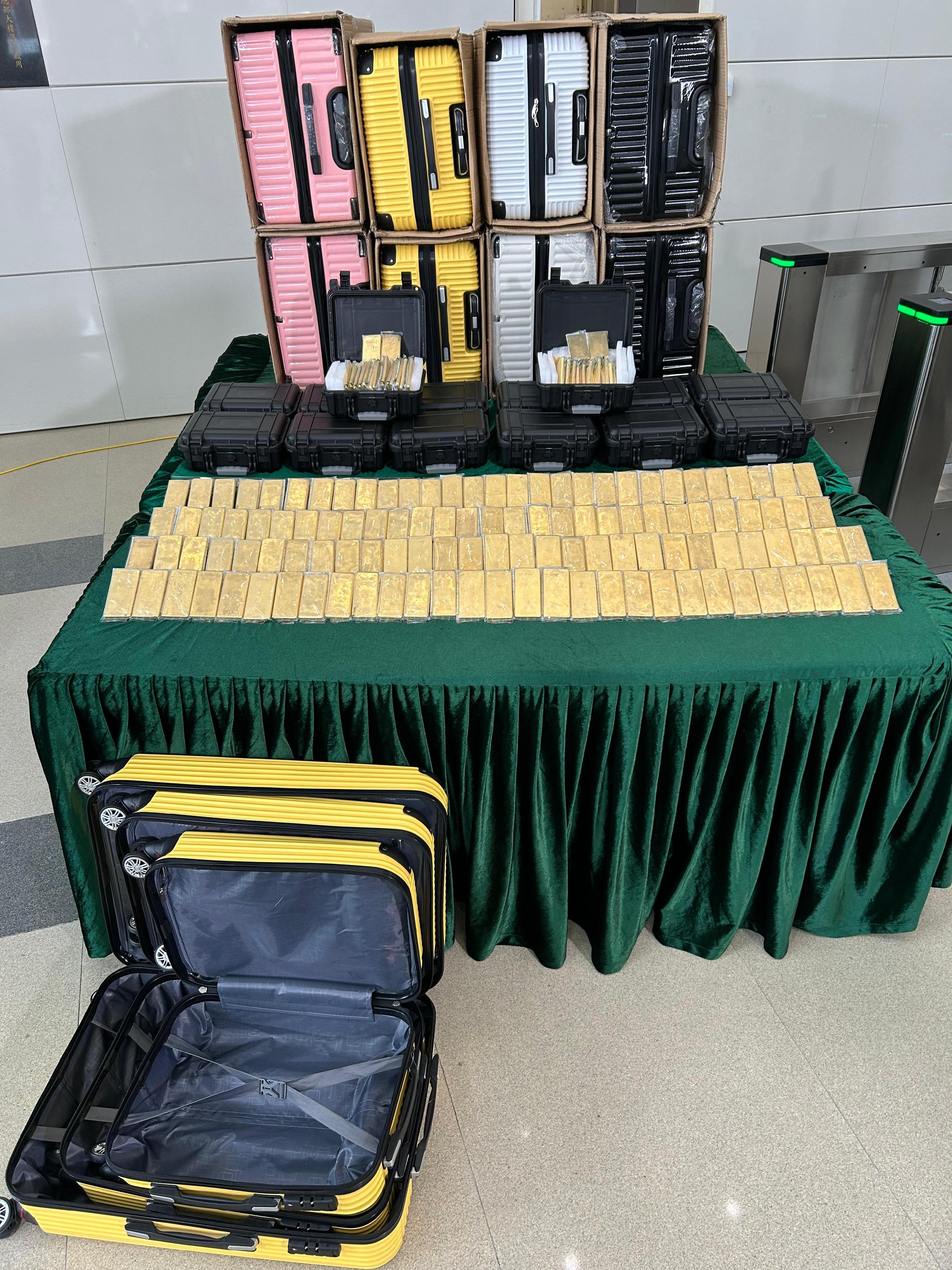 Hong Kong Customs on March 25 detected a suspected air freight gold bullion smuggling case, and seized about 145 kilograms of suspected gold bullion with an estimated market value of about $110 million at Hong Kong International Airport. This is the largest gold bullion smuggling case detected by Customs on record in terms of the seizure volume and market value. Photo shows the suspected gold bullion seized and some of the luggage used to conceal it. 
