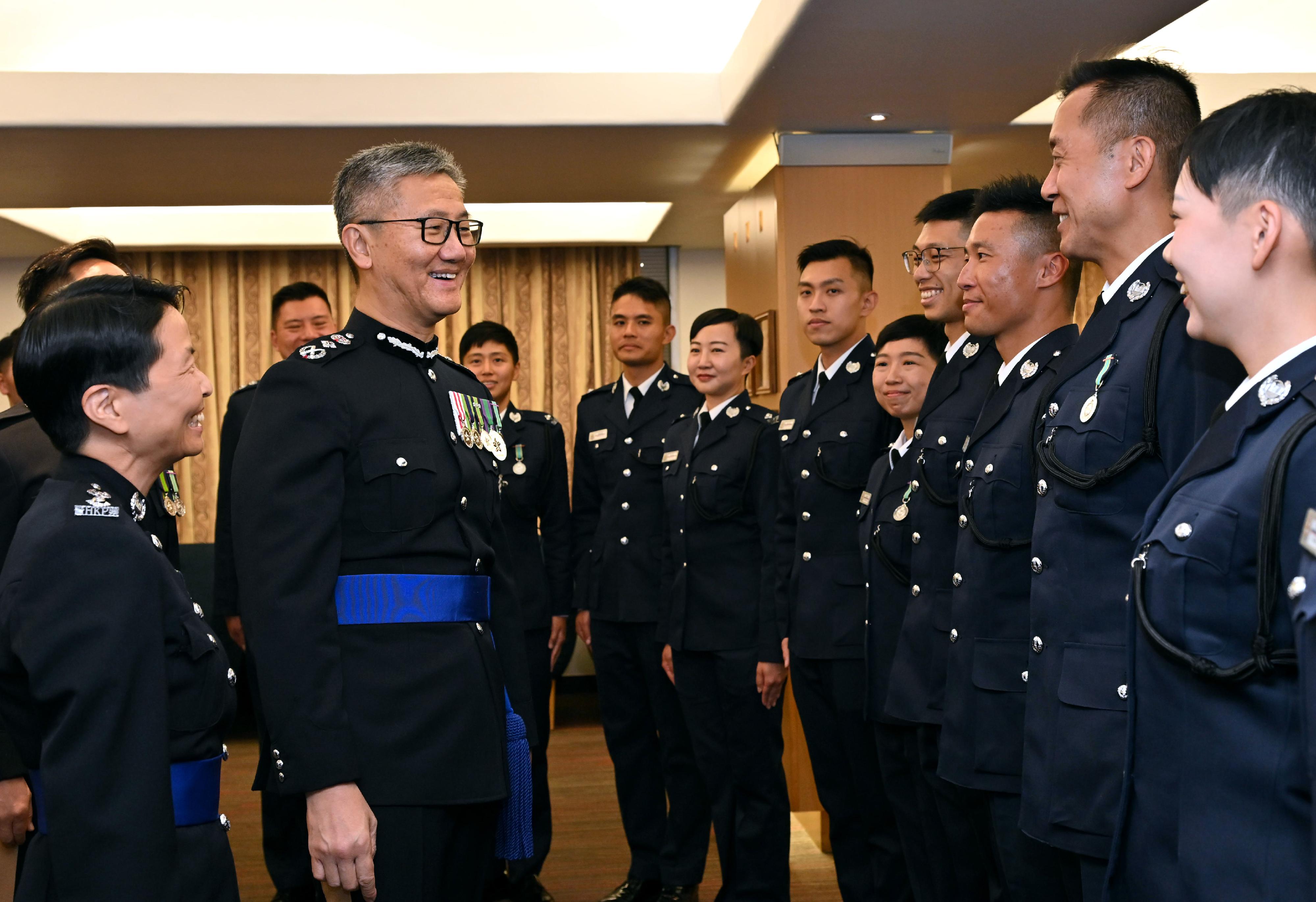The Commissioner of Police, Mr Siu Chak-yee (second left), congratulates the probationary inspectors after the passing-out parade held at the Hong Kong Police College today (March 29).