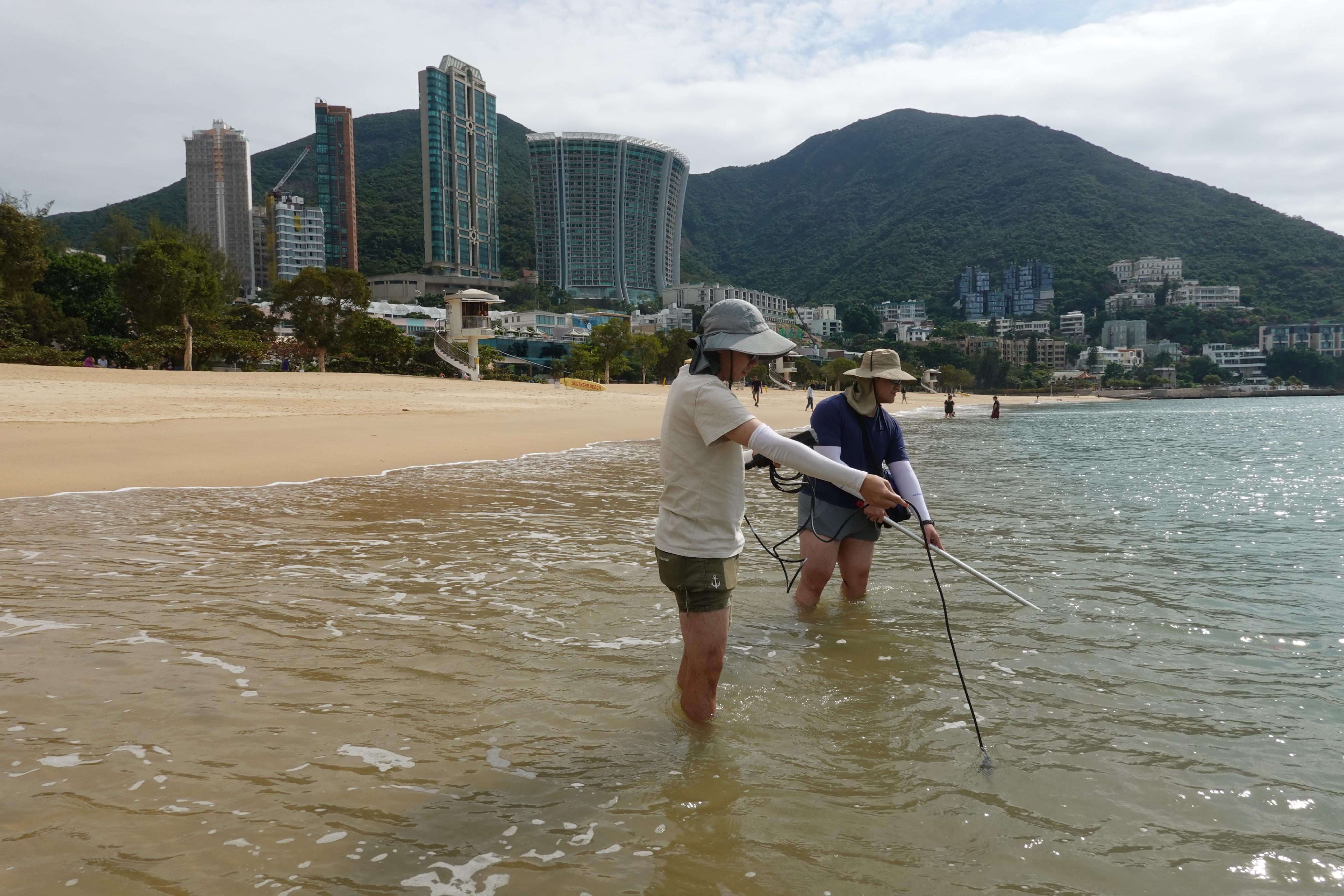 The 2024 Beach Water Quality Report reveals that all gazetted beaches in Hong Kong have fully met the Water Quality Objective for 15 consecutive years. Photo shows staff members of the Environmental Protection Department conducting on-site measurements and beach water sampling.  