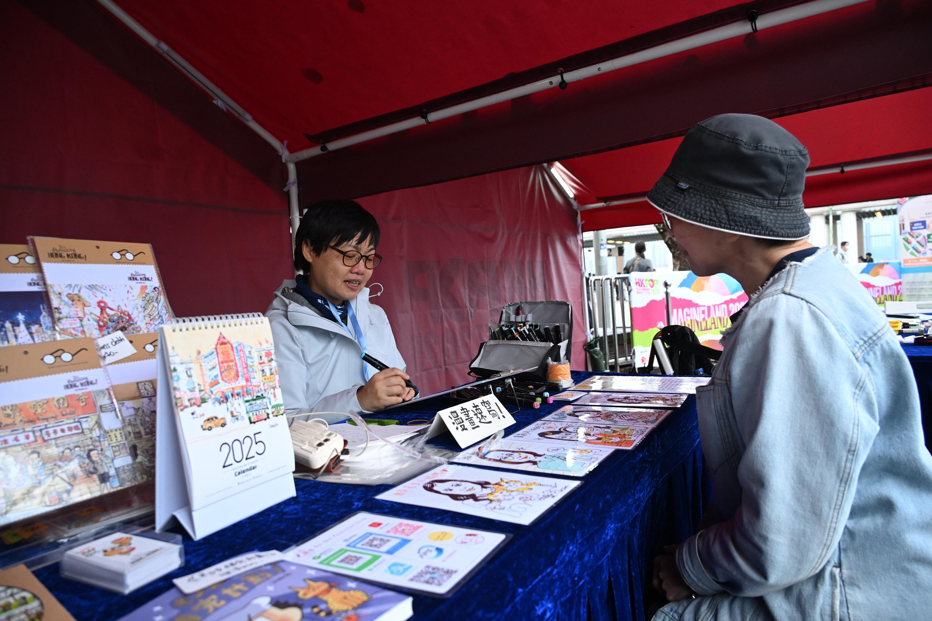 Outdoor music carnival "ImagineLand 2025", the highlight programme of the Hong Kong Pop Culture Festival 2025, is being held today and tomorrow (April 5 and 6) free of charge. Photo shows the "Funarts Corner" featuring a joyful caricature studio workshop.