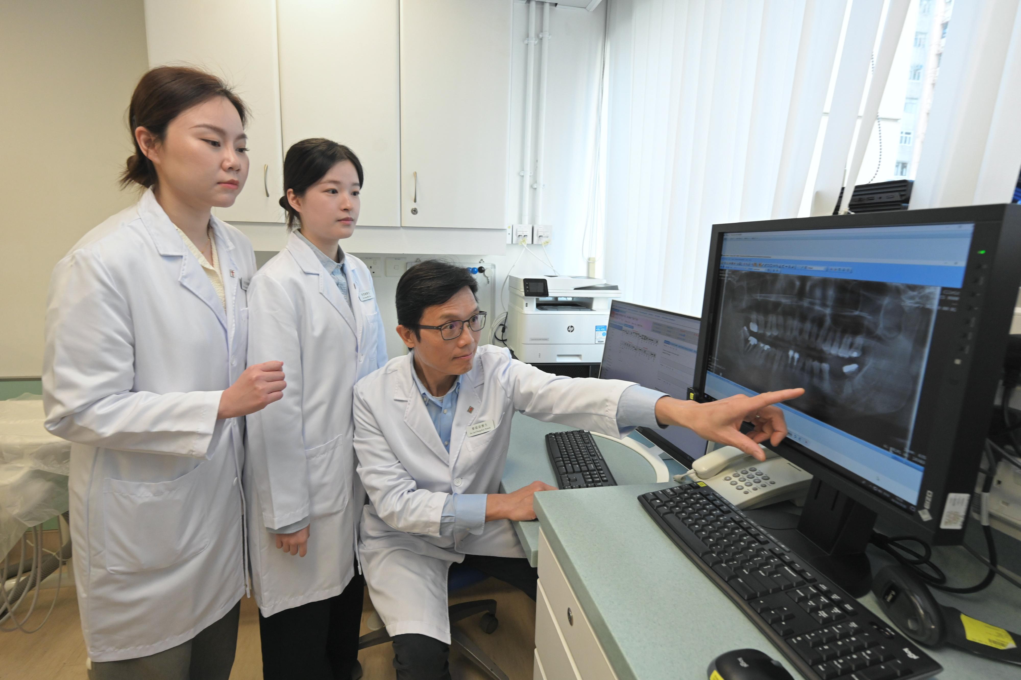 The Department of Health (DH) announced today (April 9) that the first batch of non-locally trained dentists have officially joined the DH in the first quarter of this year to provide dental services to the public. Photo shows three non-locally trained dentists analysing a dental radiography.