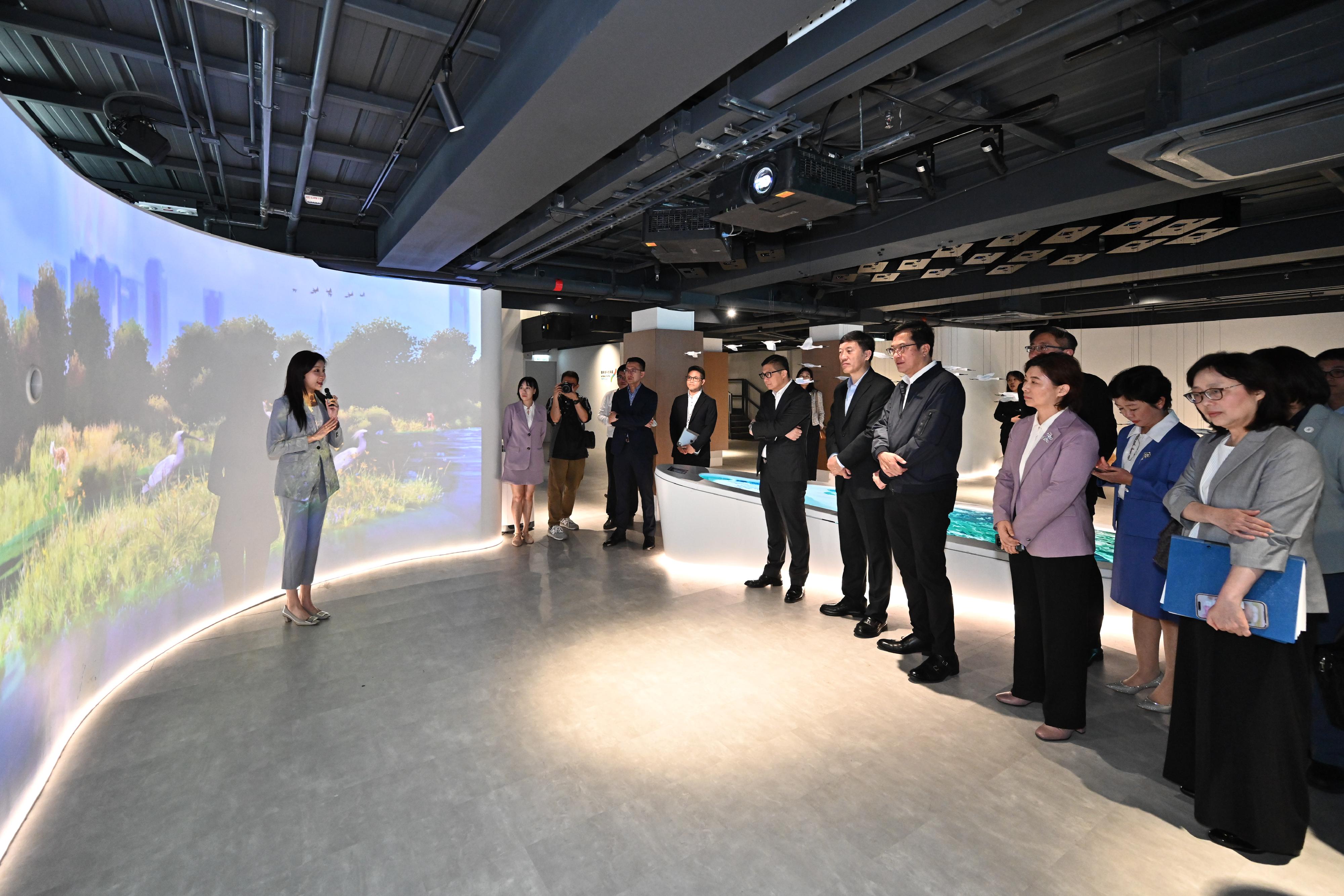 The Deputy Financial Secretary, Mr Michael Wong, and Vice Mayor of the Shenzhen Municipal People's Government Mr Tao Yongxin, leading delegations of the governments of the Hong Kong Special Administrative Region and Shenzhen respectively, held the sixth meeting of the Task Force for Collaboration on the Northern Metropolis Development Strategy in Hong Kong today (April 11). Photo shows Mr Wong (third right) and Mr Tao (fourth right) visiting the Hong Kong Park of the Hetao Shenzhen-Hong Kong Science and Technology Innovation Co-operation Zone prior to the meeting. They were briefed by a representative of the Civil Engineering and Development Department on the development of the Hong Kong Park. Looking on are the Secretary for Development, Ms Bernadette Linn (first right) and the Secretary for Security, Mr Tang Ping-keung (fifth right).