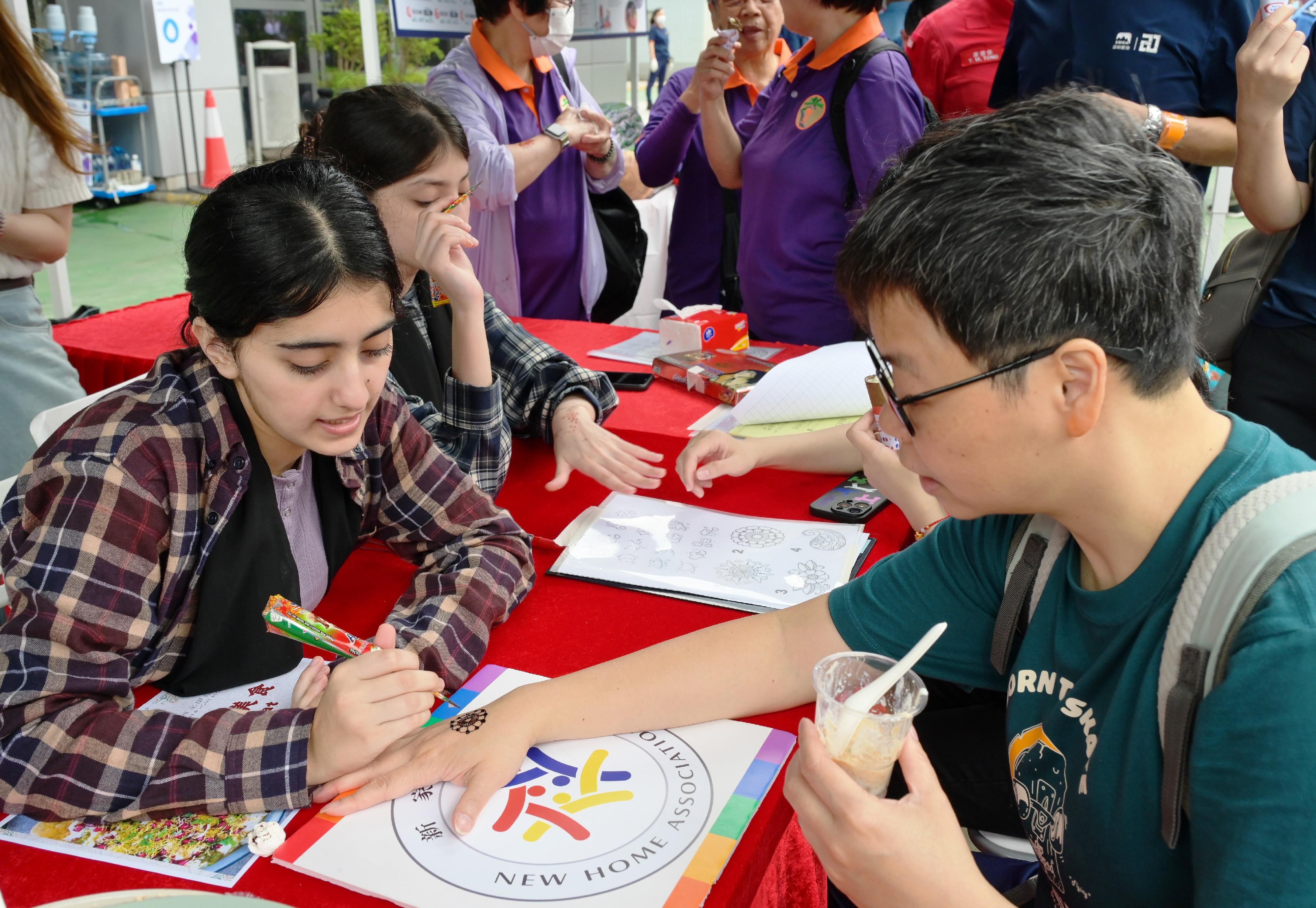 The Civil Aid Service held an open day at its headquarters today (April 12) to promote National Security Education Day. Photo shows people of diverse races introducing their cultures.