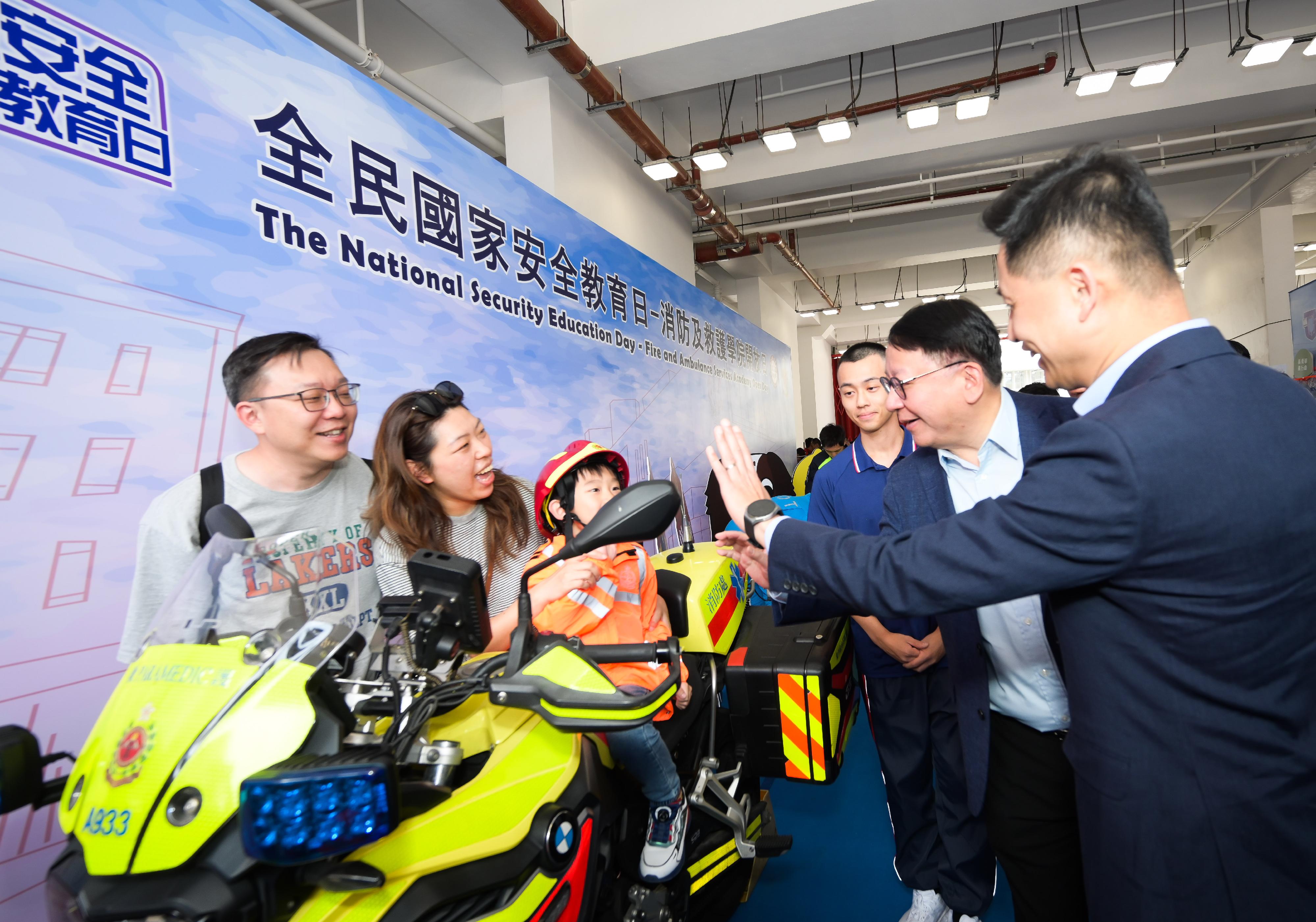 In response to and in support of the 10th National Security Education Day, the Fire Services Department held an open day today (April 13) at the Fire and Ambulance Services Academy in Tseung Kwan O. Photo shows the Chief Secretary for Administration, Mr Chan Kwok-ki (second right), accompanied by the Director of Fire Services, Mr Andy Yeung (first right), visiting the exhibition on national security.
