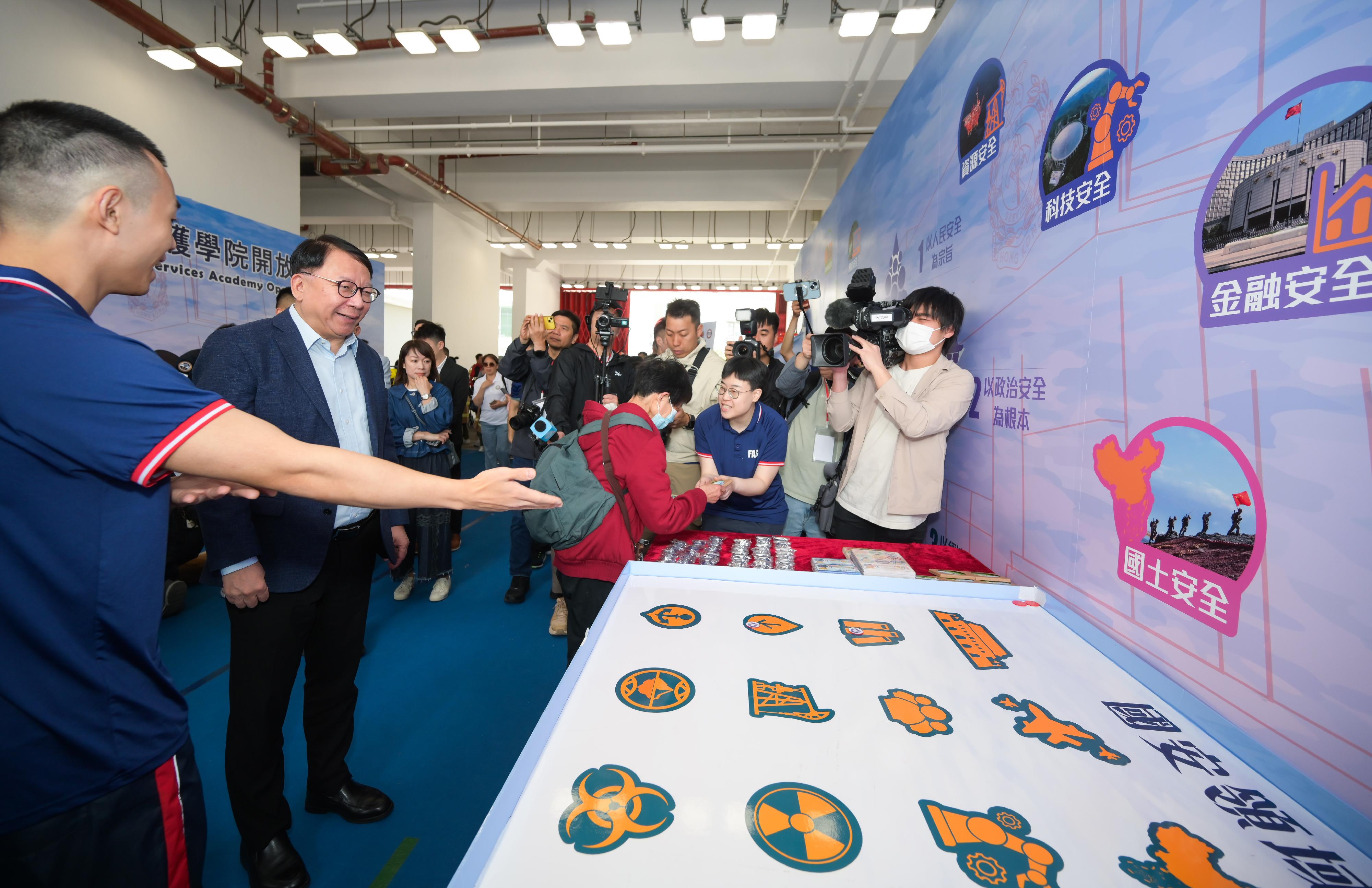 In response to and in support of the 10th National Security Education Day, the Fire Services Department held an open day today (April 13) at the Fire and Ambulance Services Academy in Tseung Kwan O. Photo shows the Chief Secretary for Administration, Mr Chan Kwok-ki (second left), visiting the exhibition on national security.