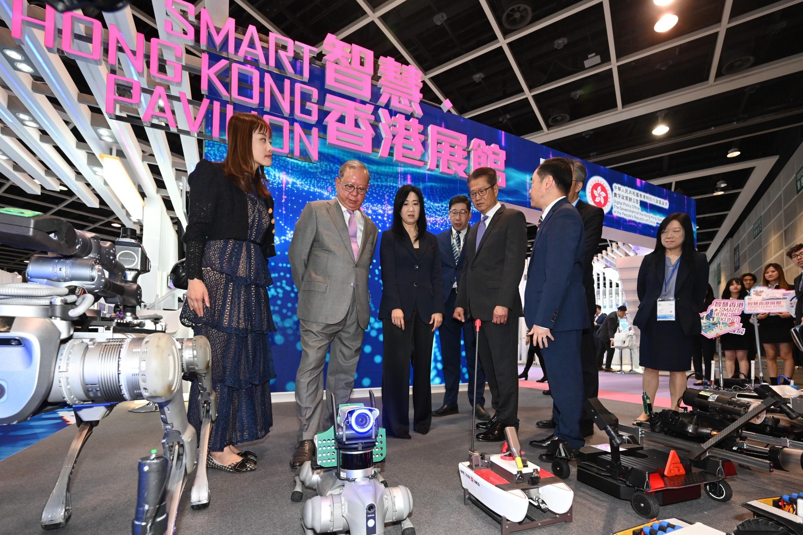 The Financial Secretary, Mr Paul Chan (fifth left), visited the Smart Hong Kong Pavilion at InnoEX today (April 13) and learned about various robots displayed in the "Smart People" area. Looking on are the Under Secretary for Innovation, Technology and Industry, Ms Lillian Cheong (first left); the Commissioner for Digital Policy, Mr Tony Wong (sixth left); and the Chairman of the Hong Kong Trade Development Council, Dr Peter Lam (second left).