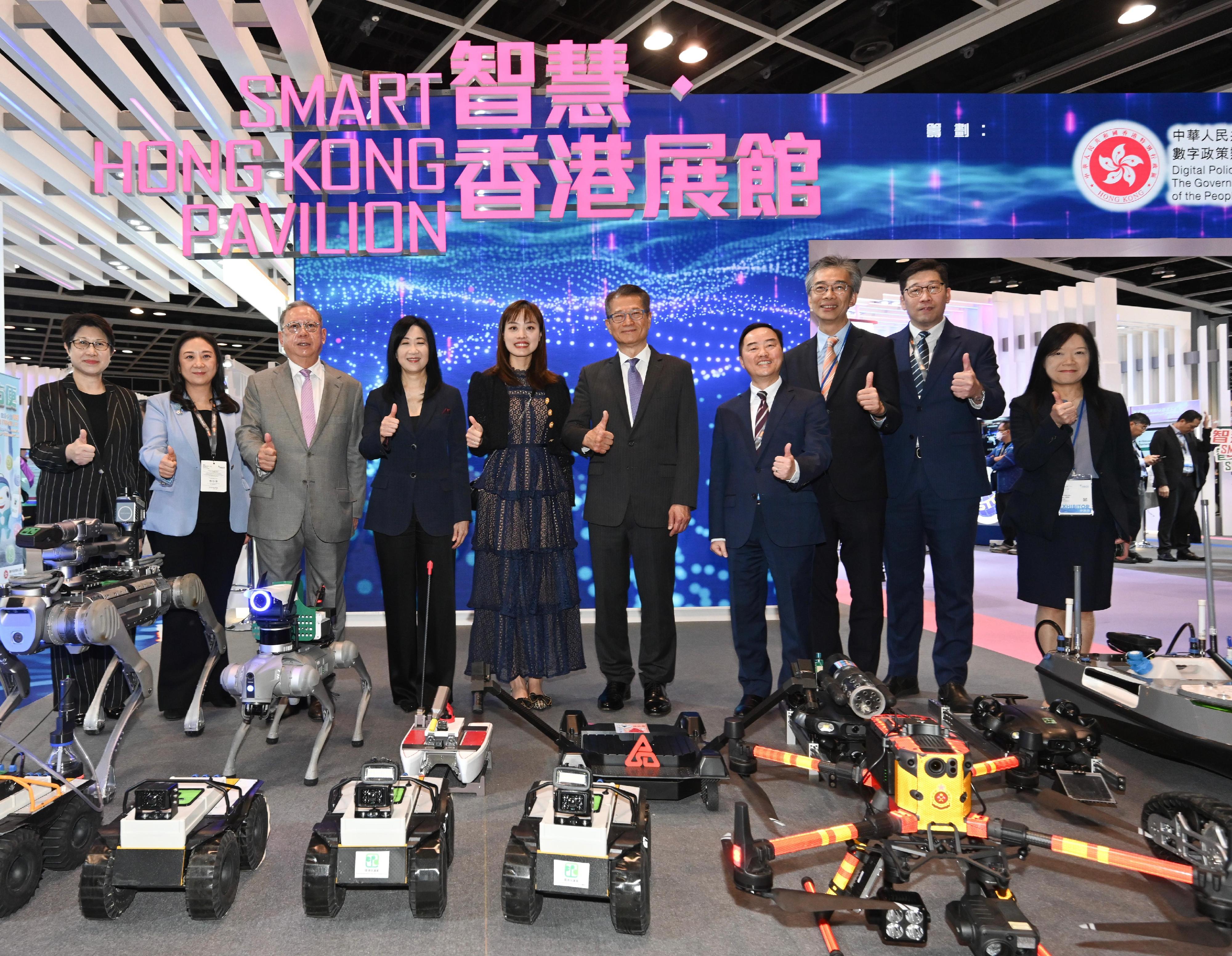 The Financial Secretary, Mr Paul Chan (fifth right), visited the Smart Hong Kong Pavilion at InnoEX today (April 13) to learn about innovation and technology solutions of various government departments and was pictured with the Under Secretary for Innovation, Technology and Industry, Ms Lillian Cheong (fifth left); the Commissioner for Digital Policy, Mr Tony Wong (fourth right); and the Chairman of the Hong Kong Trade Development Council, Dr Peter Lam (third left).