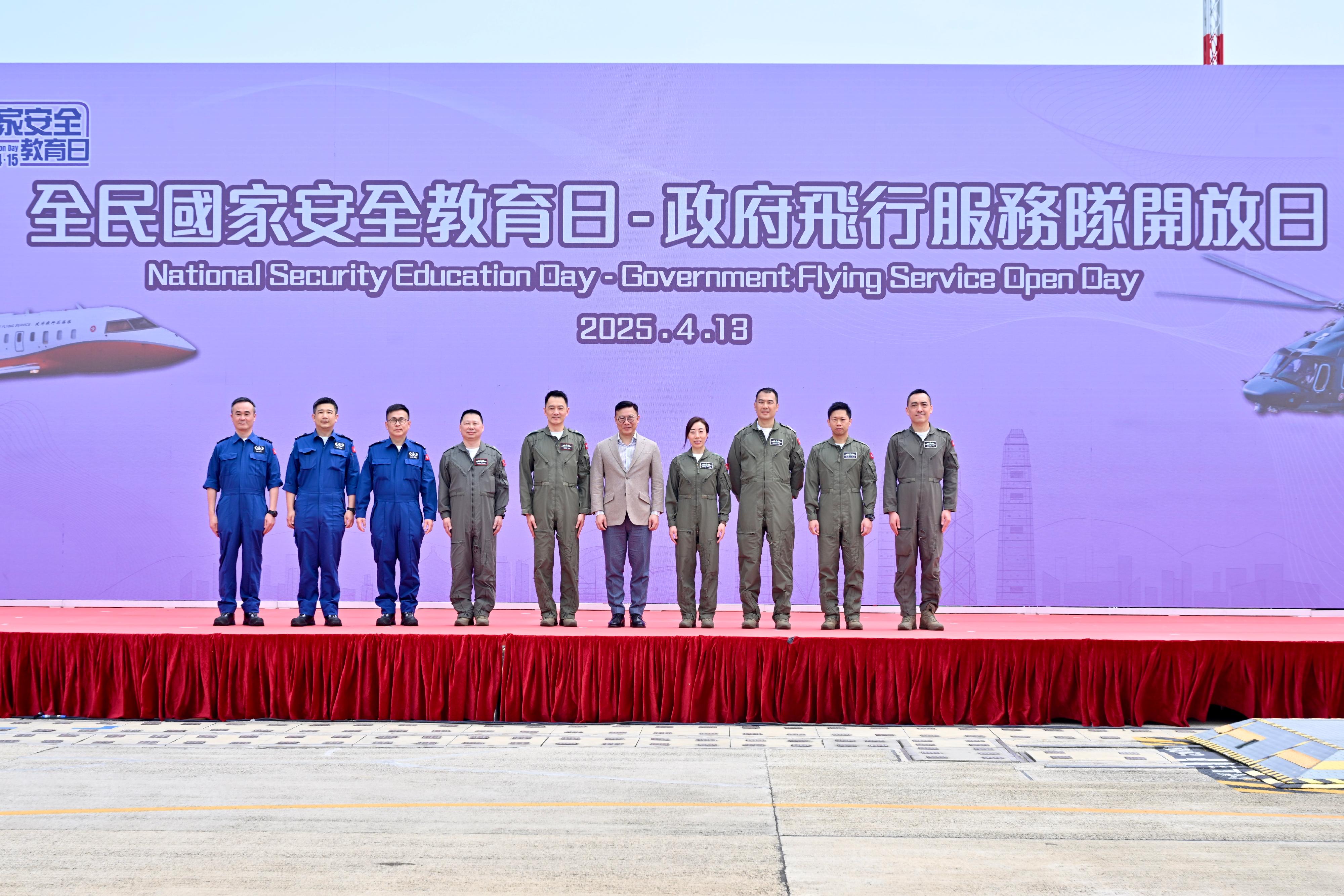 To promote the National Security Education Day, the Government Flying Service (GFS) held an open day today (April 13) at the GFS Kai Tak Division. Photo shows the Deputy Secretary for Justice, Dr Cheung Kwok-kwan (fifth right), with the Controller of GFS, Captain Eddie Liu (fifth left), and senior officers of GFS.
