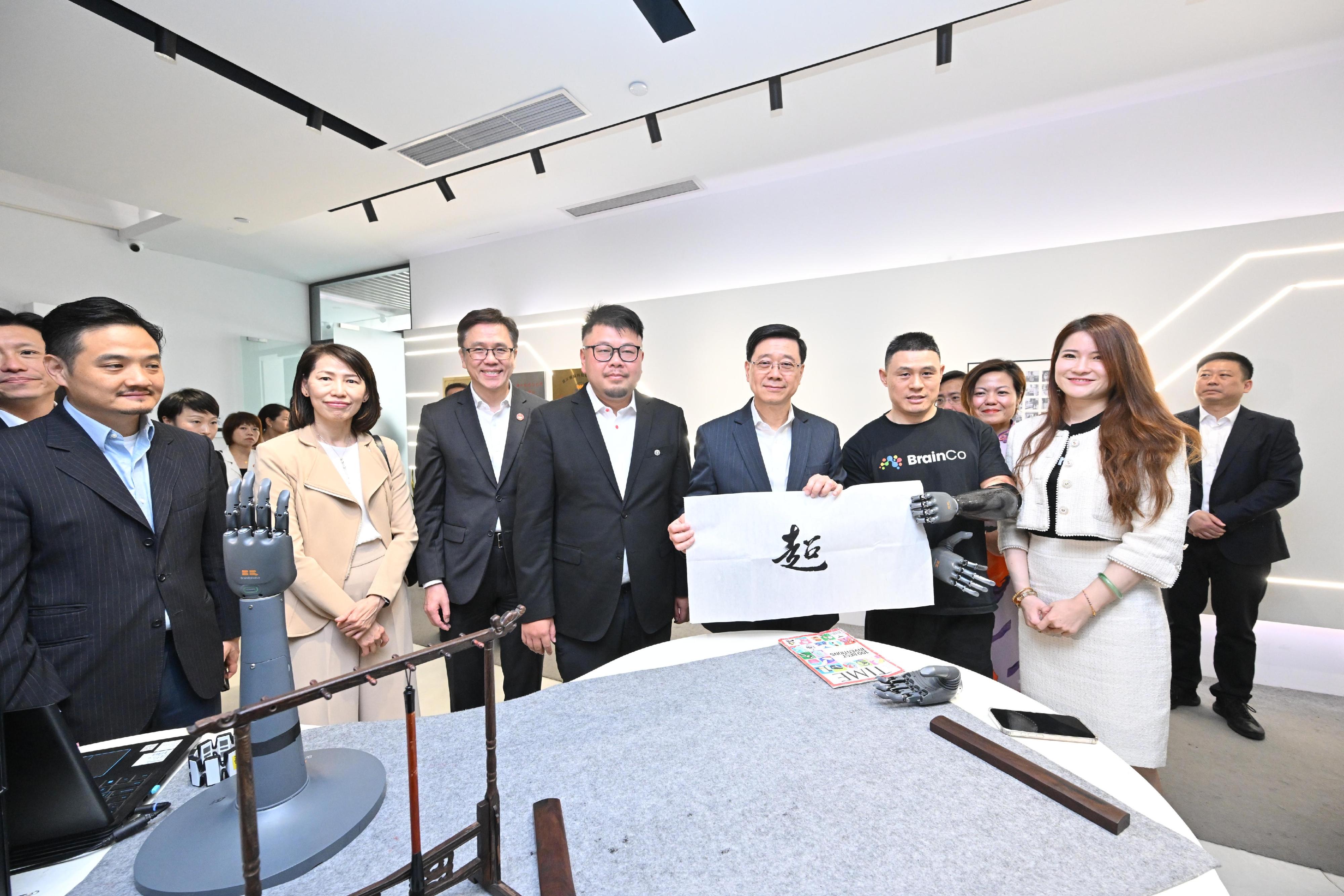 The Chief Executive, Mr John Lee, continued his visit to Hangzhou today (April 23). Photo shows Mr Lee (fifth right) visiting BrainCo.