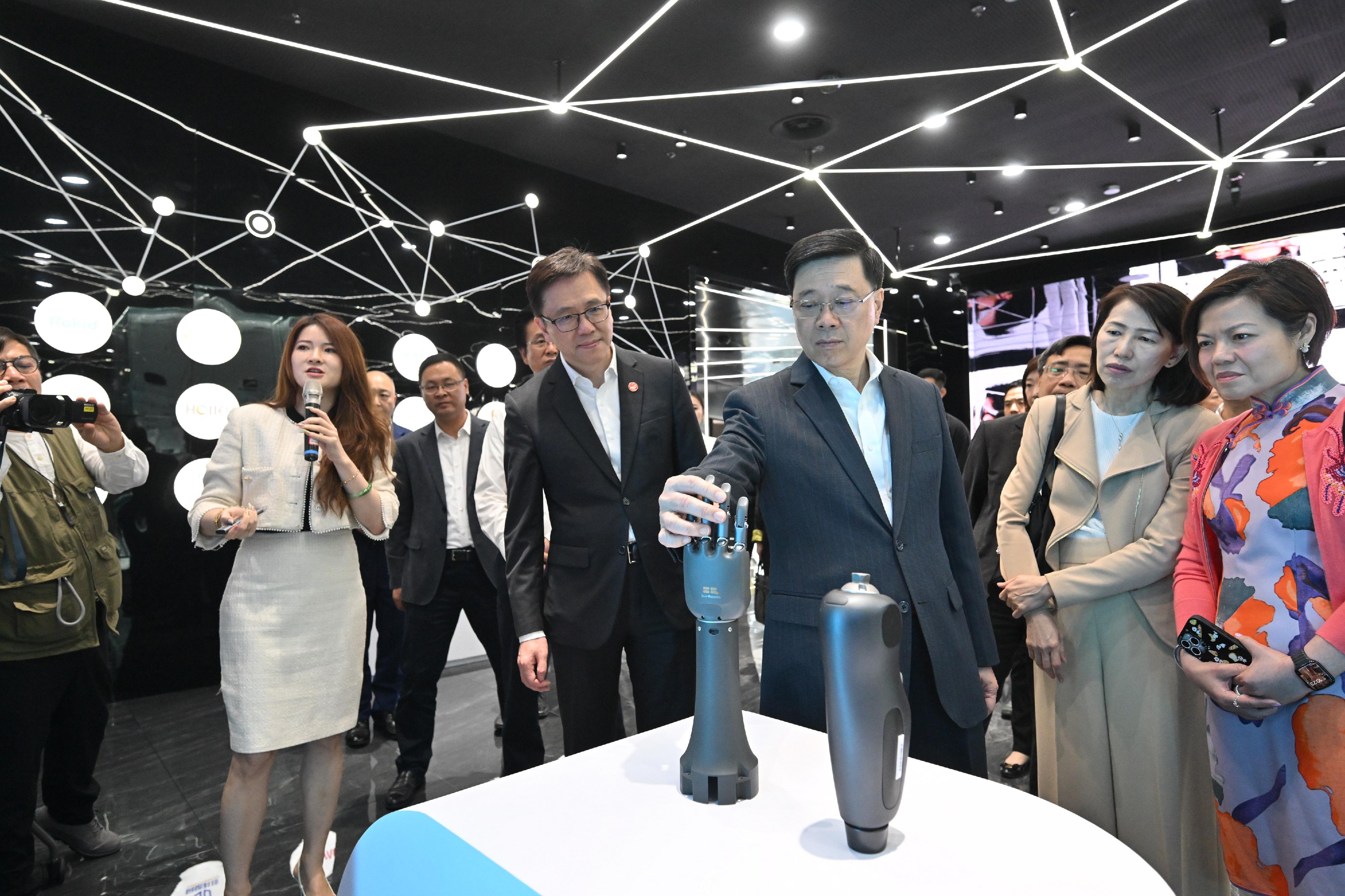 The Chief Executive, Mr John Lee, continued his visit to Hangzhou today (April 23). Photo shows Mr Lee (third right) visiting the Hangzhou Future Sci-Tech City Urban Exhibition Center and the exhibition of BrainCo.