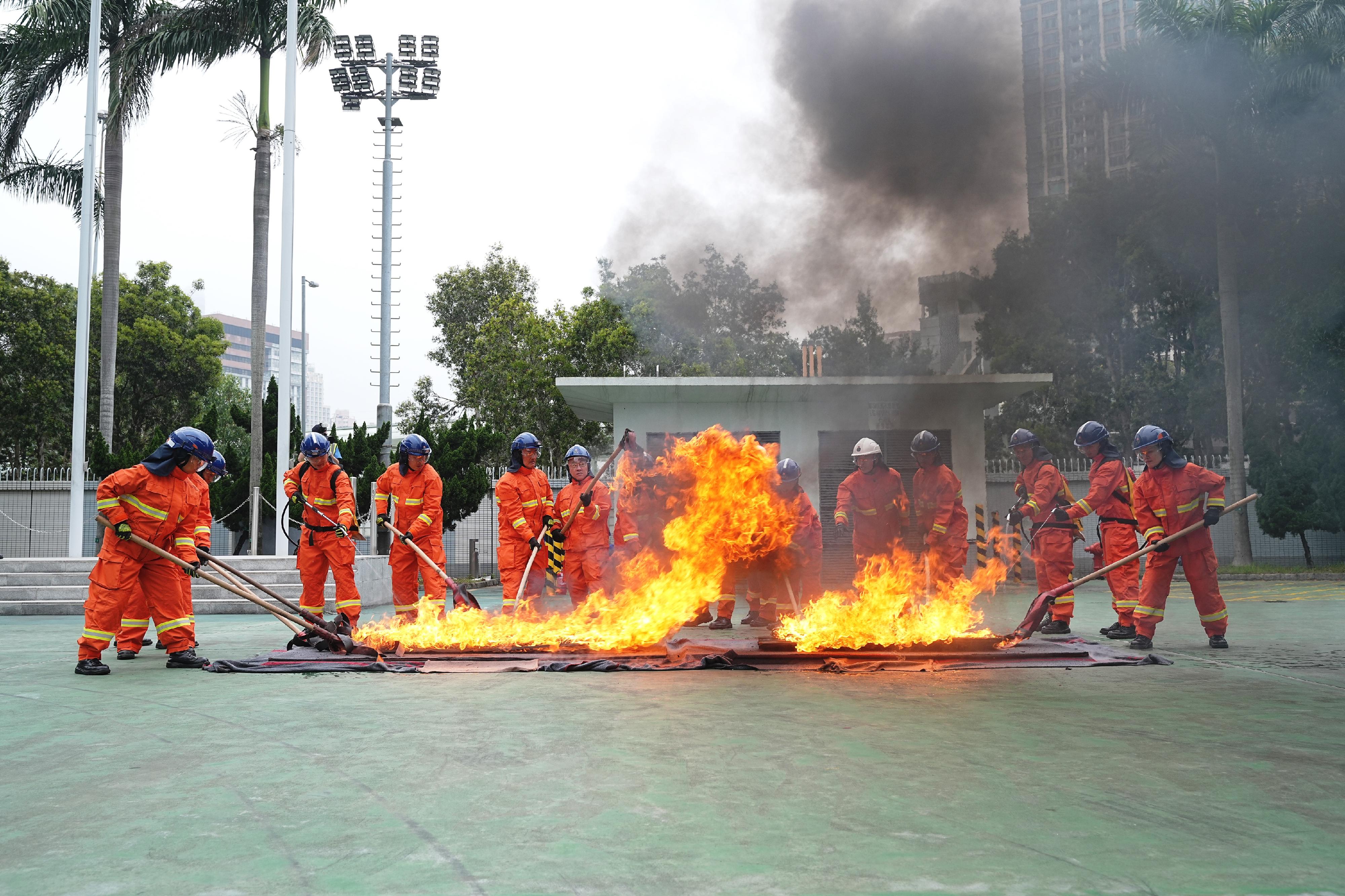 The Civil Aid Service held the Passing-out Parade for the 90th Recruits and 13th Tactical Force Secondment Scheme at its headquarters today (April 27). Photo shows the recruits staging a vegetation firefighting and a rescue demonstration.