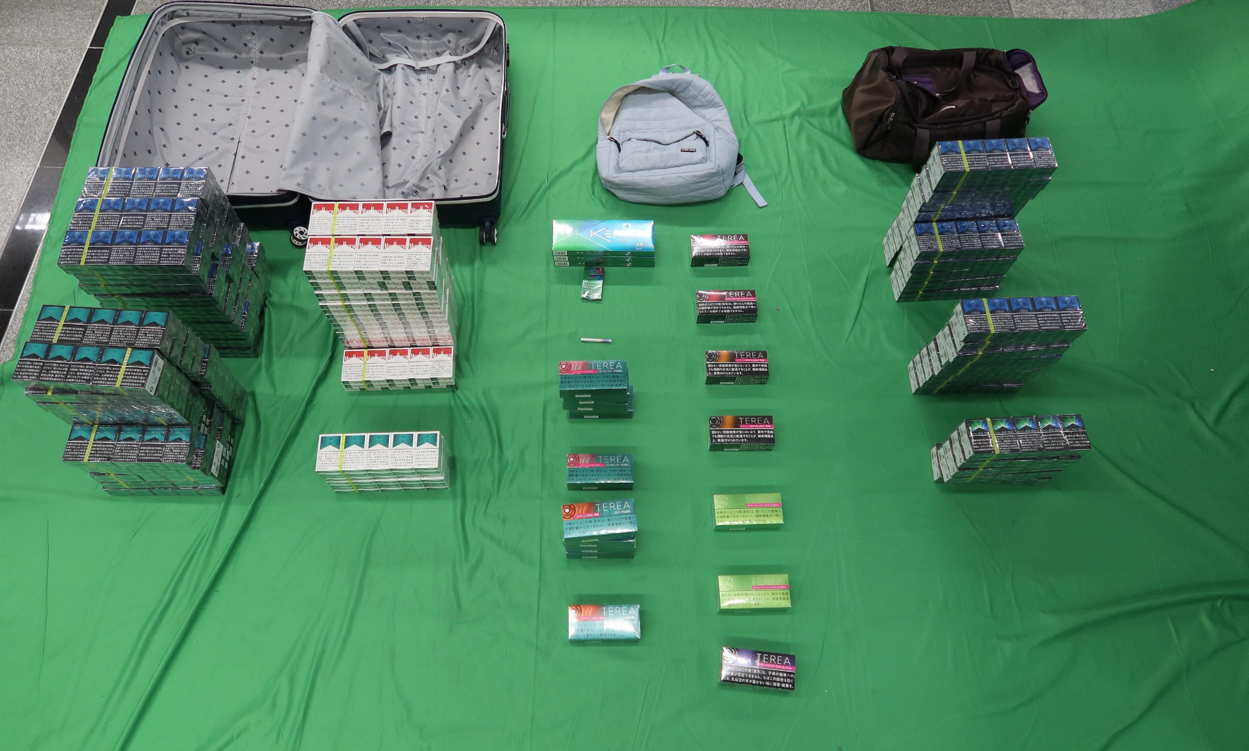 Two incoming female passengers, aged 31 and 30, were sentenced to four months' imprisonment and fined $500 at the West Kowloon Magistrates' Courts today (April 29) for importing duty-not-paid cigarettes and failing to declare to Customs officers, as well as for importing alternative smoking products, in contravention of the Dutiable Commodities Ordinance and the Import and Export Ordinance. Photo shows the duty-not-paid cigarettes and alternative smoking products seized.
