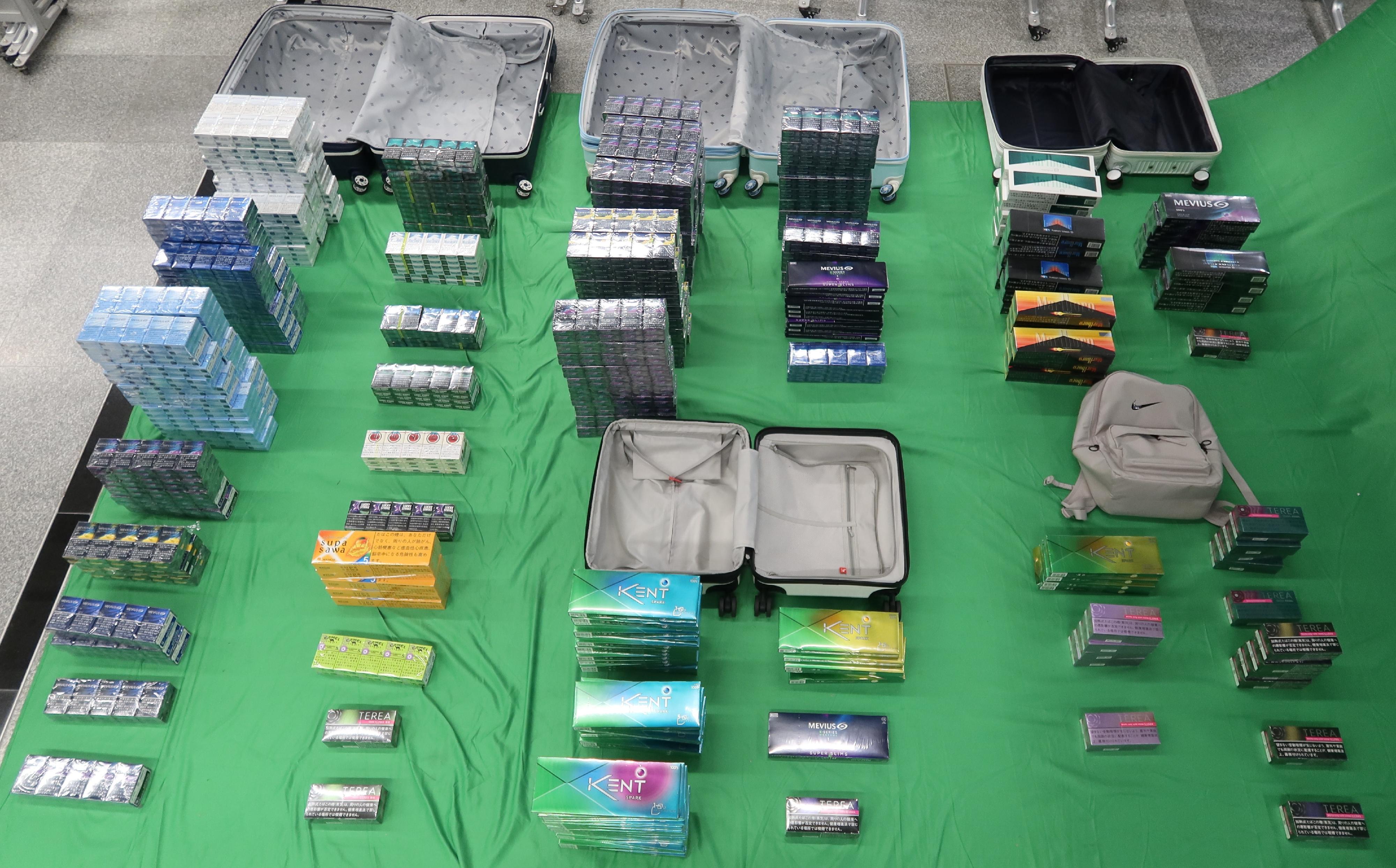 Two incoming female passengers, aged 31 and 30, were sentenced to four months' imprisonment and fined $500 at the West Kowloon Magistrates' Courts today (April 29) for importing duty-not-paid cigarettes and failing to declare to Customs officers, as well as for importing alternative smoking products, in contravention of the Dutiable Commodities Ordinance and the Import and Export Ordinance. Photo shows the duty-not-paid cigarettes and alternative smoking products seized.

