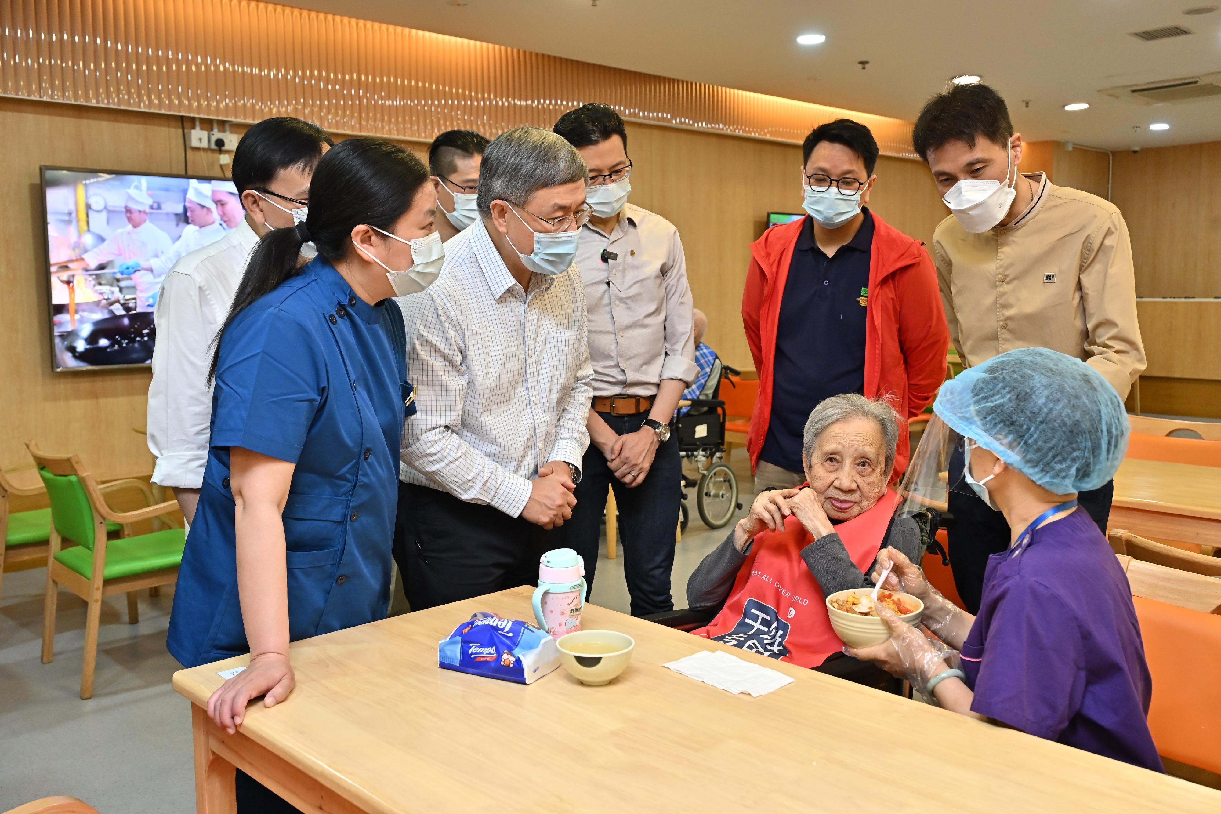 政務司副司長卓永興（左二）今日（五月一日）探訪將軍澳安老院舍前線員工，感謝正在餵飯的員工對長者的悉心照顧。
