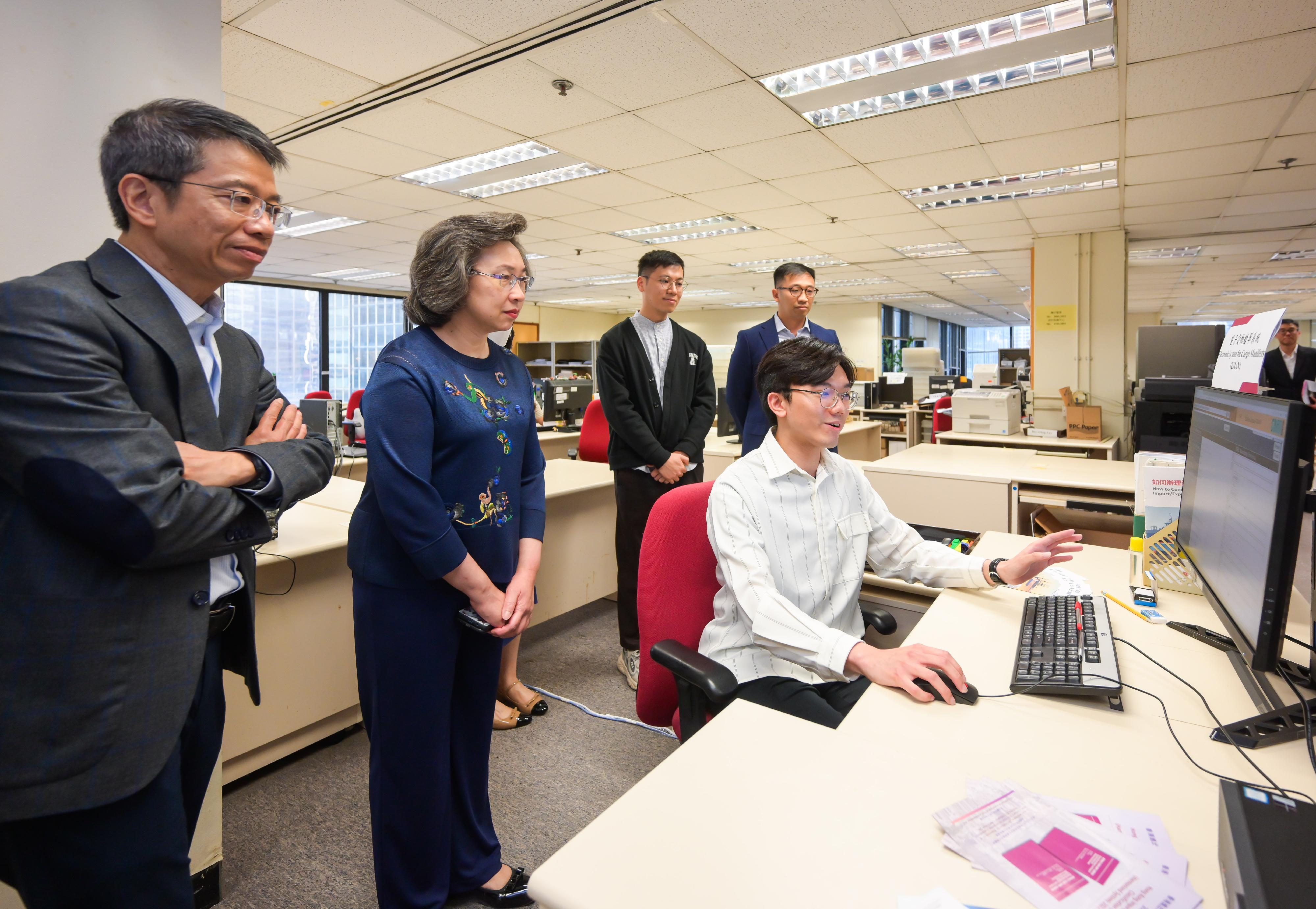 The Secretary for the Civil Service, Mrs Ingrid Yeung, visited the Census and Statistics Department this afternoon (May 2). Photo shows Mrs Yeung (second left) being briefed by the staff on an in-house developed AI model applied to the Electronic System for Cargo Manifests to assist in matching the corresponding import/export declarations and cargo manifests, thus reducing the need for manual checks. Looking on is the Permanent Secretary for the Civil Service, Mr Clement Leung (first left).