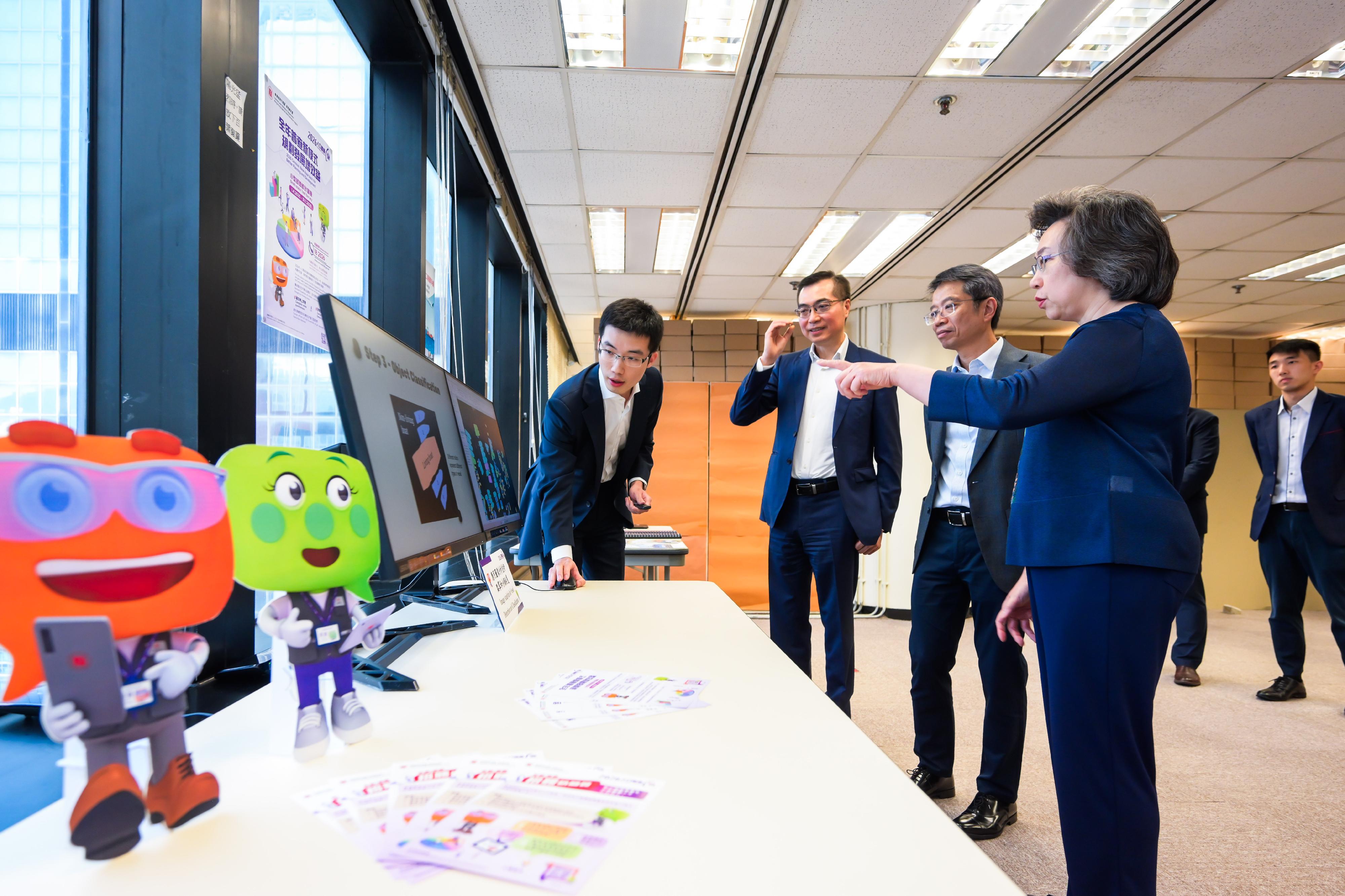 The Secretary for the Civil Service, Mrs Ingrid Yeung, visited the Census and Statistics Department (C&SD) this afternoon (May 2). Photo shows Mrs Yeung (first right) being brief by staff on the C&SD's new approach to conducting the 2026 Population Census. Through the application of image analysis to detect and classify vessels, the manpower required for the enumeration of marine population will be reduced.