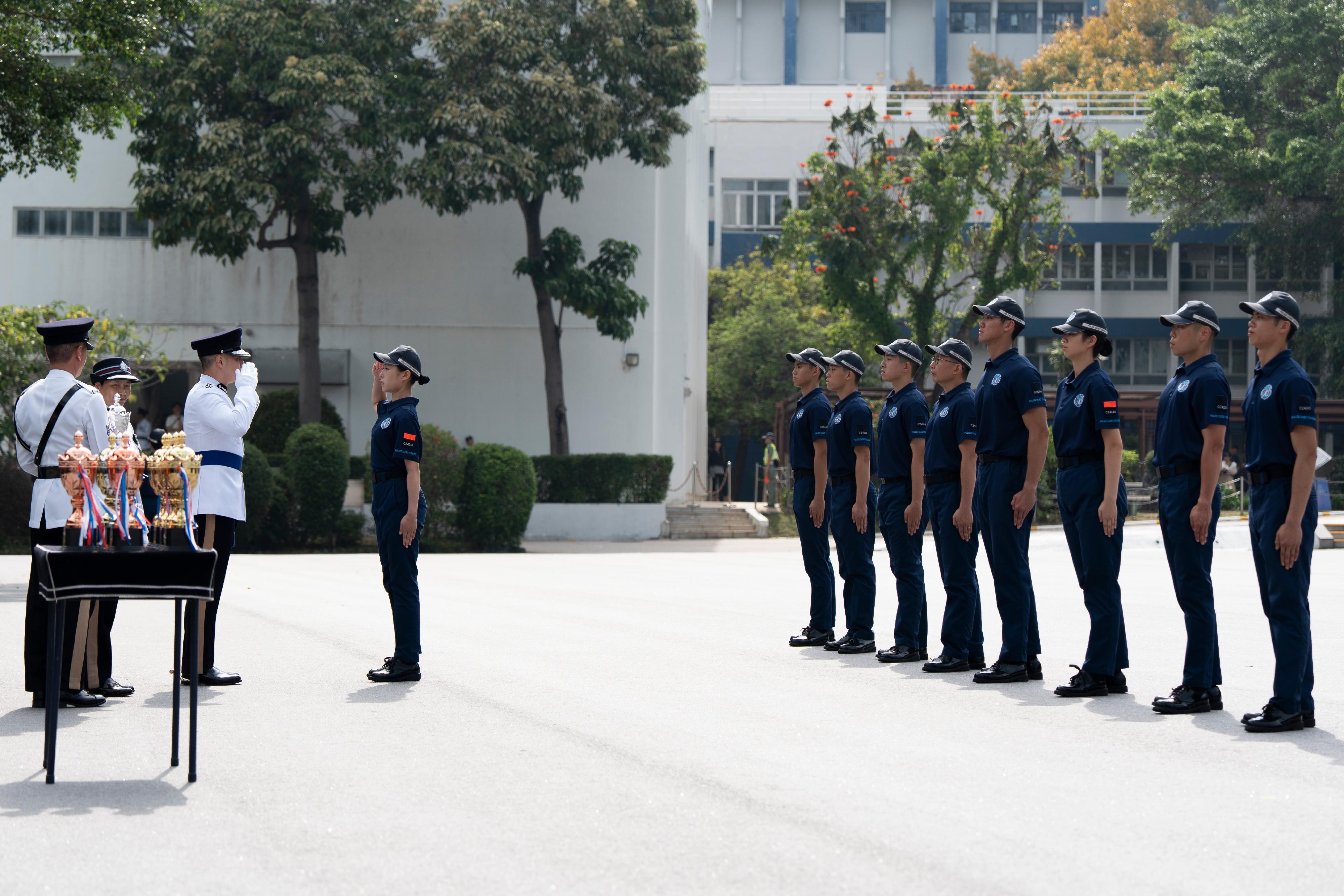 The Commissioner of Police, Mr Chow Yat-ming, inspects a passing-out parade of the Police Cadet Training held at the Hong Kong Police College today (May 3), presenting awards to outstanding graduates.