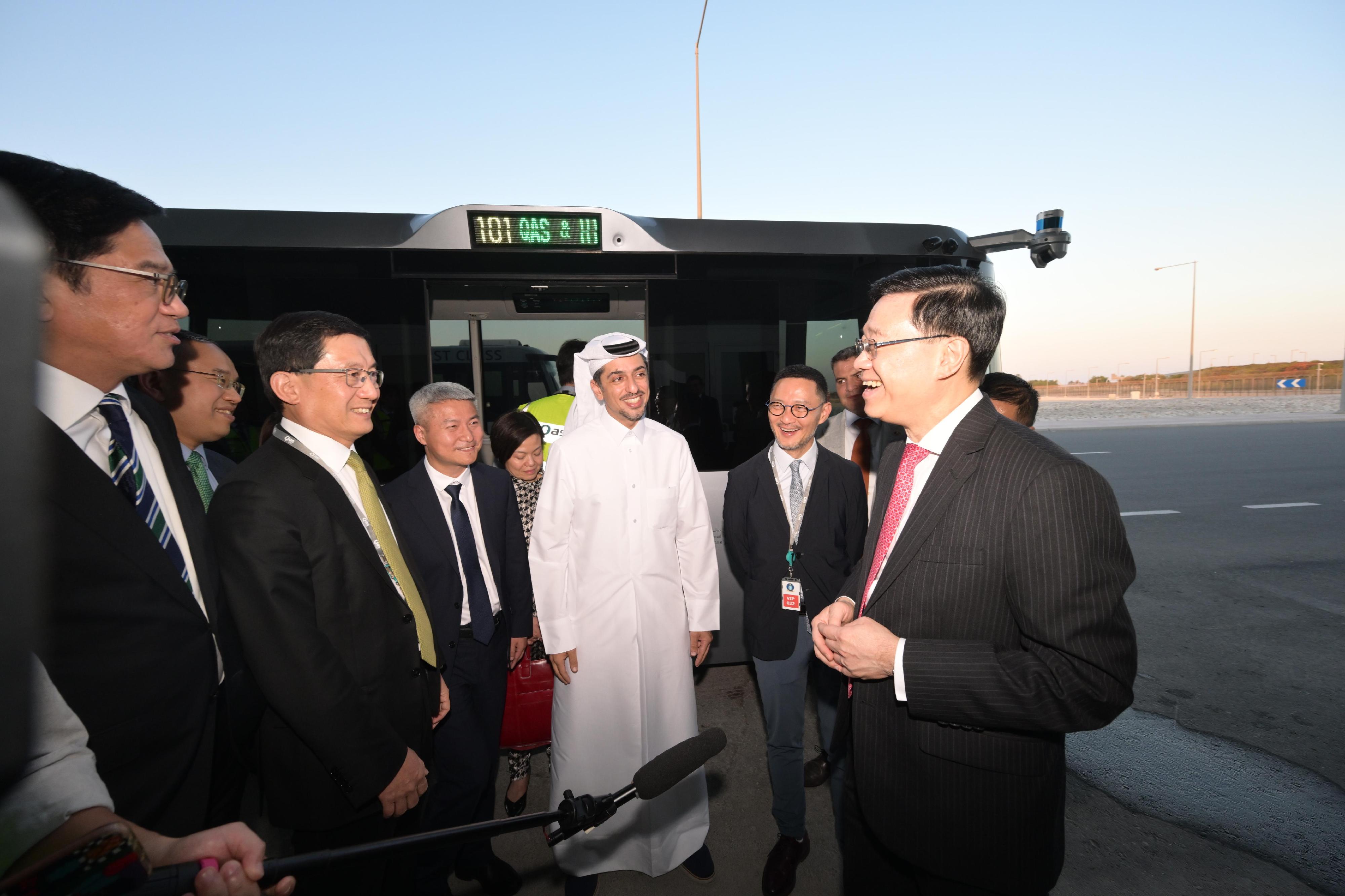 The Chief Executive, Mr John Lee, today (May 12) learned about the operation and effectiveness of the autonomous vehicle system pilot scheme in Hamad International Airport in Doha, Qatar. Photo shows Mr Lee (first right) being briefed on the operation of the vehicles of UISEE, a Mainland Chinese company with its international headquarters in Hong Kong participating in the pilot scheme.