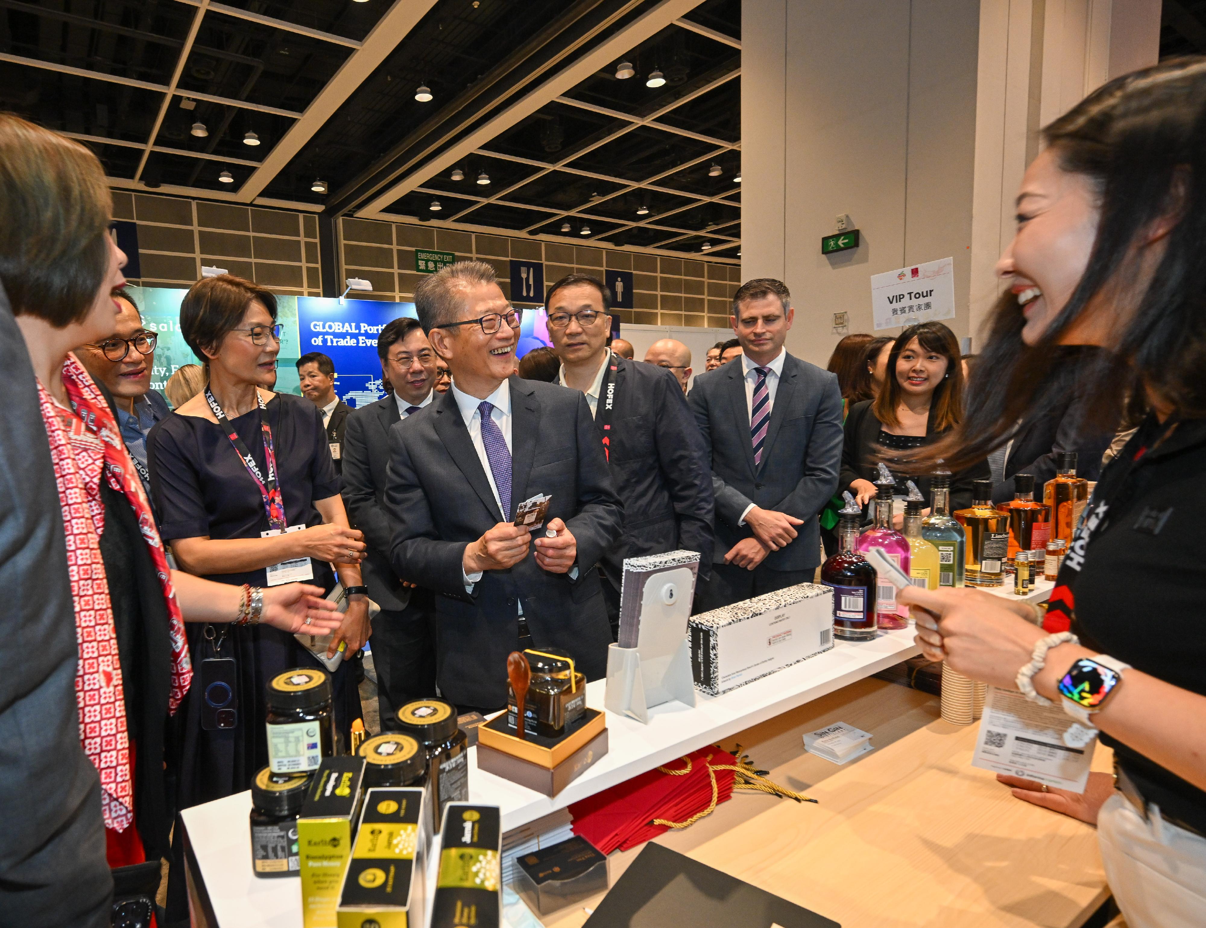 The Financial Secretary, Mr Paul Chan, attended the HOFEX and ProWine Hong Kong @ HOFEX Opening Ceremony today (May 14). Photo shows Mr Chan (front row, third left) touring the exhibition and exchanging views with an exhibitor.