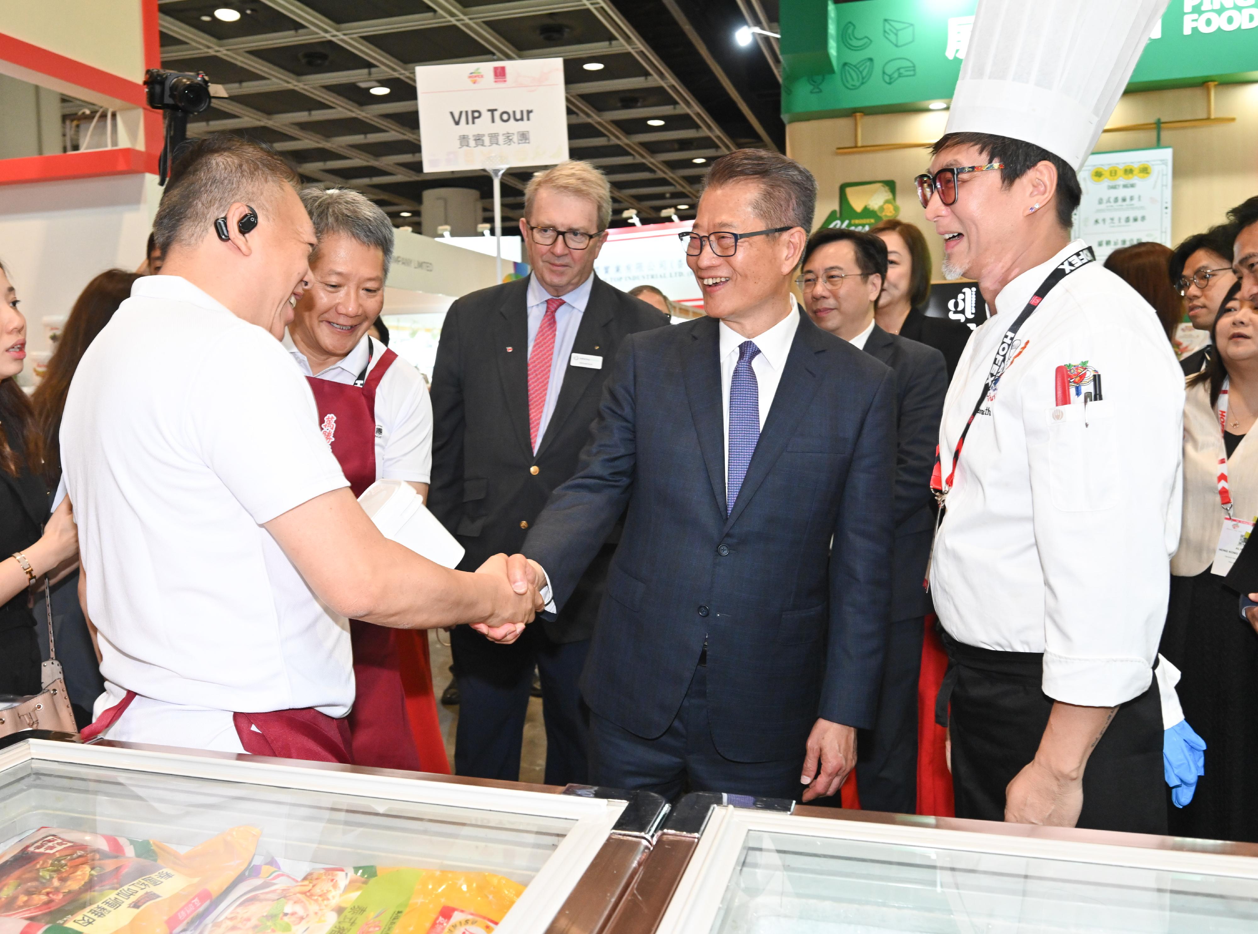 The Financial Secretary, Mr Paul Chan, attended the HOFEX and ProWine Hong Kong @ HOFEX Opening Ceremony today (May 14). Photo shows Mr Chan (second right) touring the exhibition and exchanging views with an exhibitor.