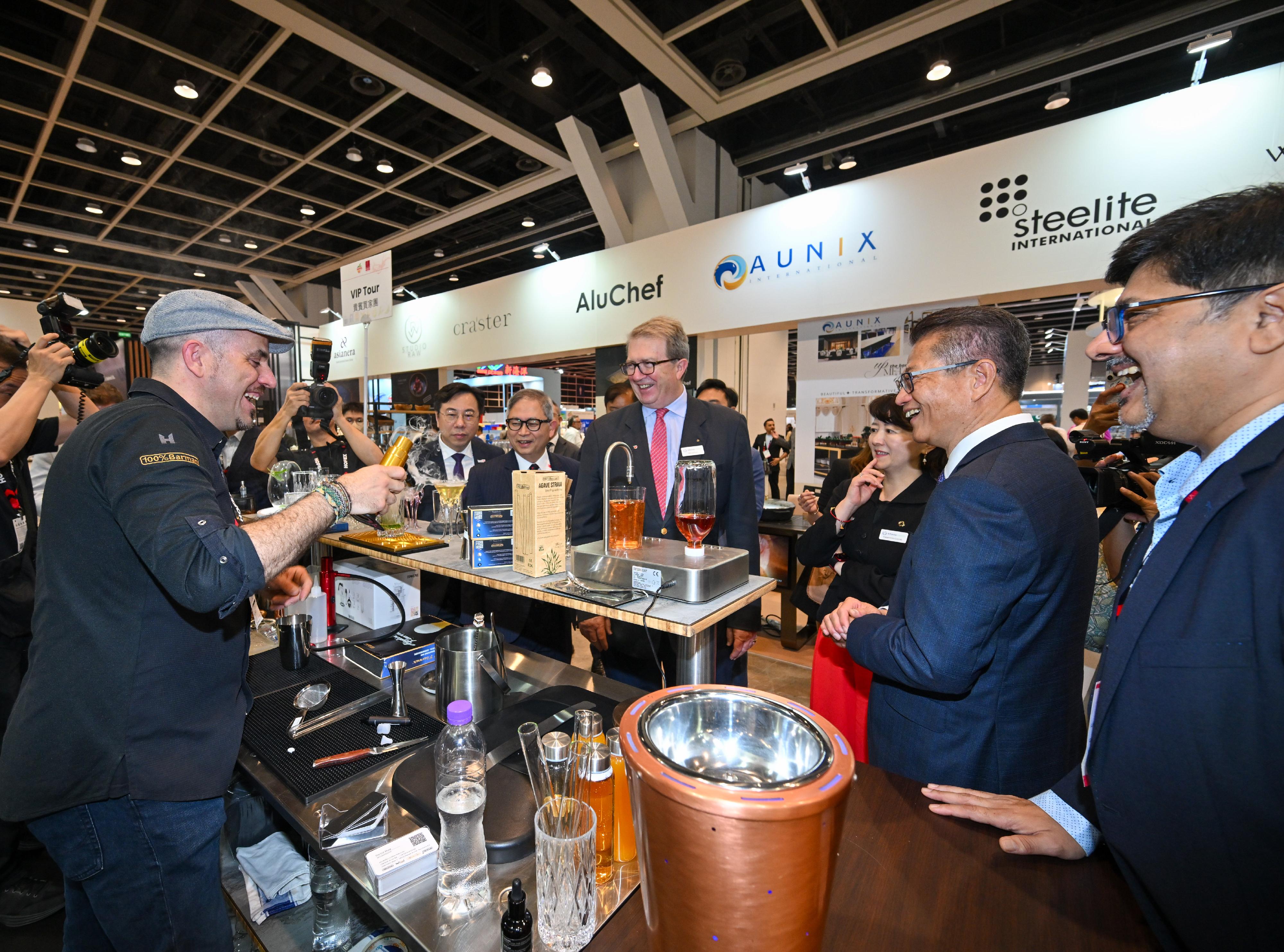 The Financial Secretary, Mr Paul Chan, attended the HOFEX and ProWine Hong Kong @ HOFEX Opening Ceremony today (May 14). Photo shows Mr Chan (second right) touring the exhibition and exchanging views with an exhibitor.