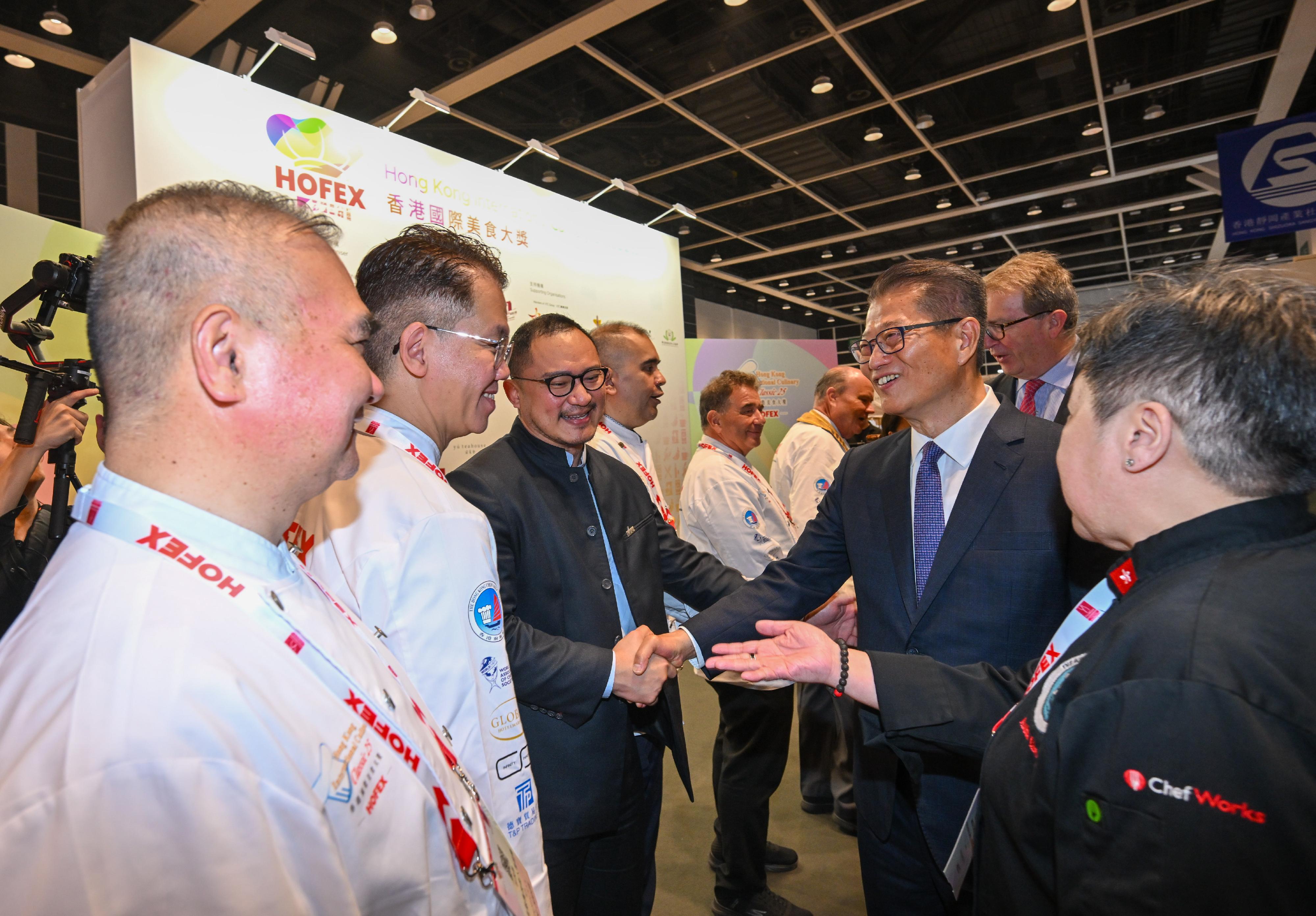 The Financial Secretary, Mr Paul Chan, attended the HOFEX and ProWine Hong Kong @ HOFEX Opening Ceremony today (May 14). Photo shows Mr Chan (second right) exchanging views with guests at the event.