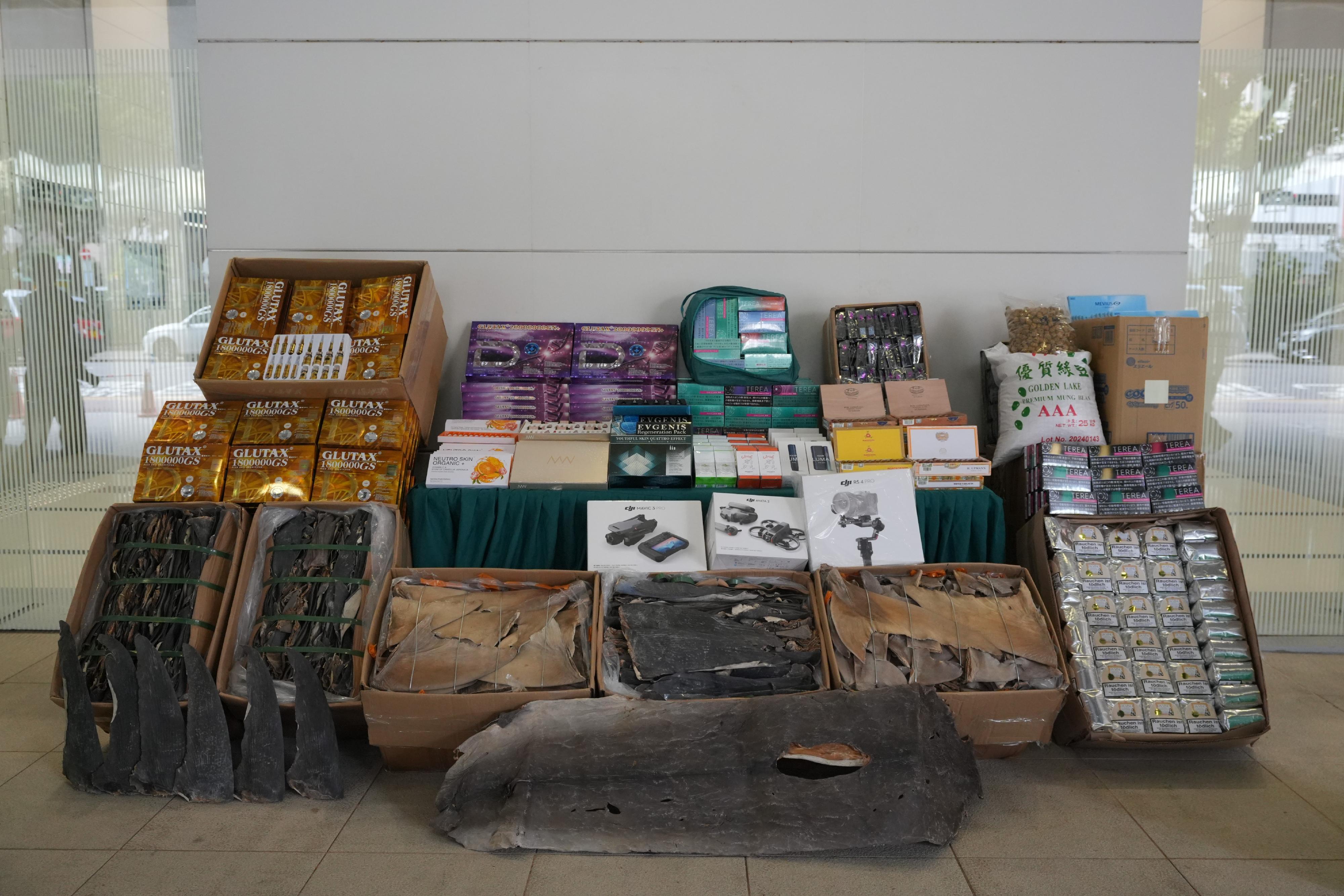 Hong Kong Customs on May 9 detected a suspected smuggling case involving a river trade vessel. A large batch of suspected smuggled goods with a total estimated market value of about $28 million was seized. Photo shows the suspected smuggled goods seized, including electronic parts, beauty needles, alternative smoking products, suspected duty-not-paid tobacco products, suspected scheduled dried shark fins and expensive food ingredients.