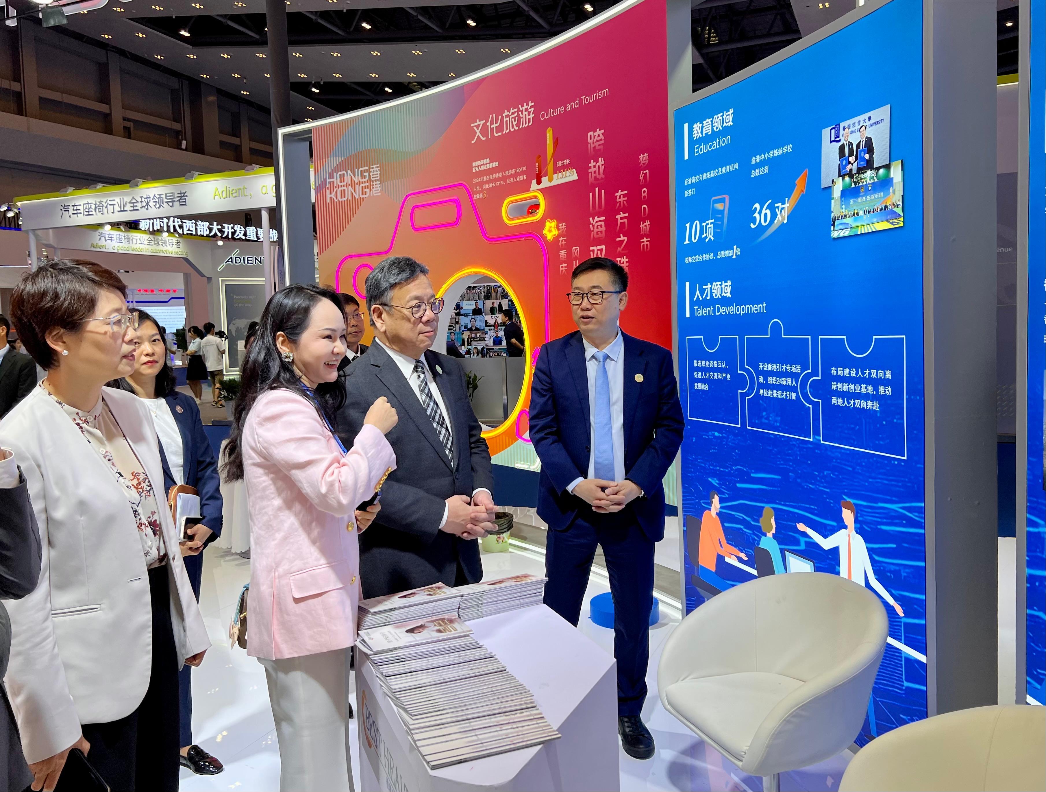The Secretary for Commerce and Economic Development, Mr Algernon Yau, attended the Seventh Western China International Fair for Investment and Trade in Chongqing today (May 22). A Hong Kong Pavilion is set up at the fair to promote Hong Kong's strengths and showcase its role as an effective and premium trade and business platform for Mainland enterprises to go global. Photo shows Mr Yau (second right) touring the Hong Kong Pavilion to learn about the achievements of the co-operation between Hong Kong and Chongqing  in various areas.