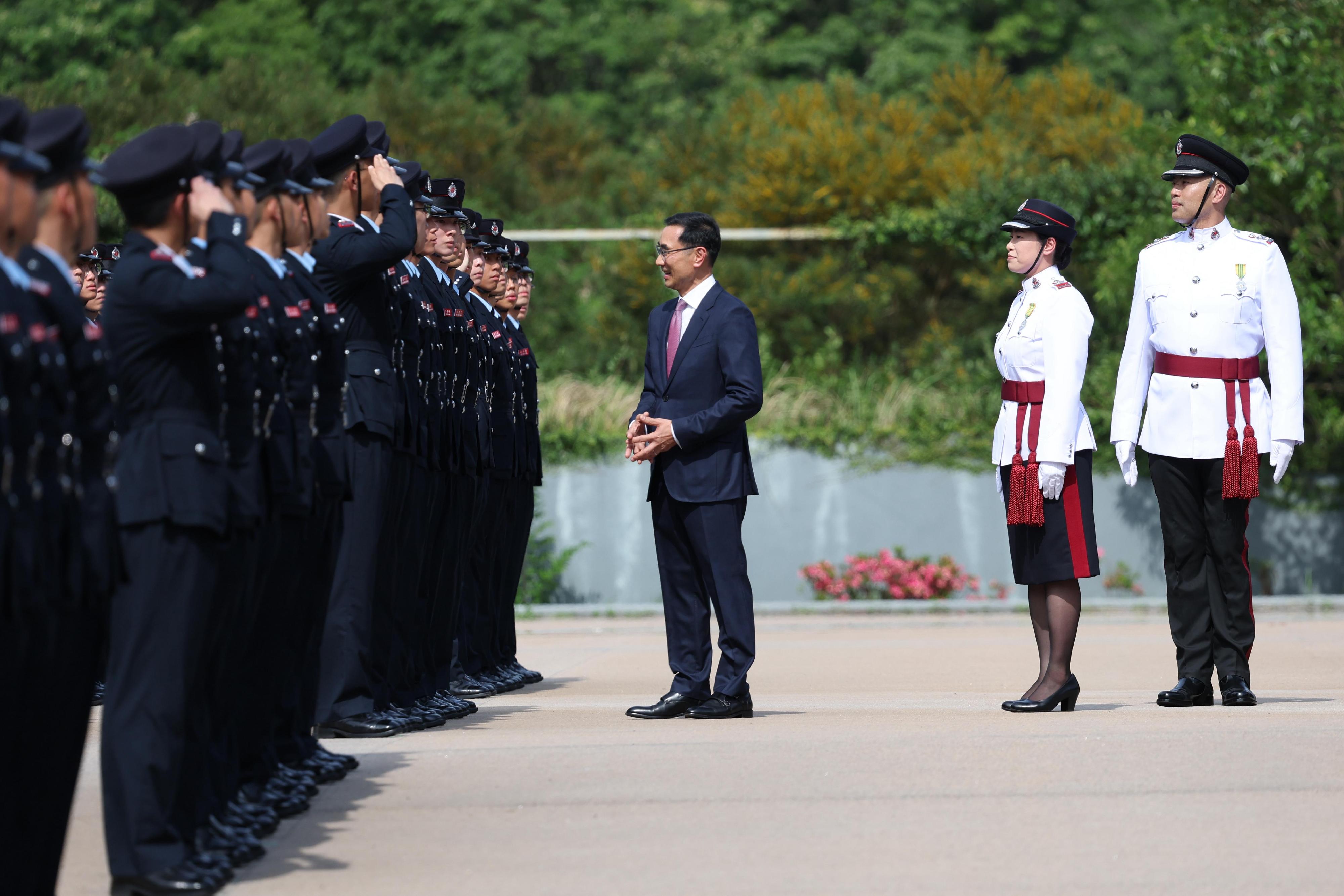 The Chairman of the Hong Kong Jockey Club, Mr Michael Lee (third right), reviews the Fire Services passing-out parade at the Fire and Ambulance Services Academy today (May 23).