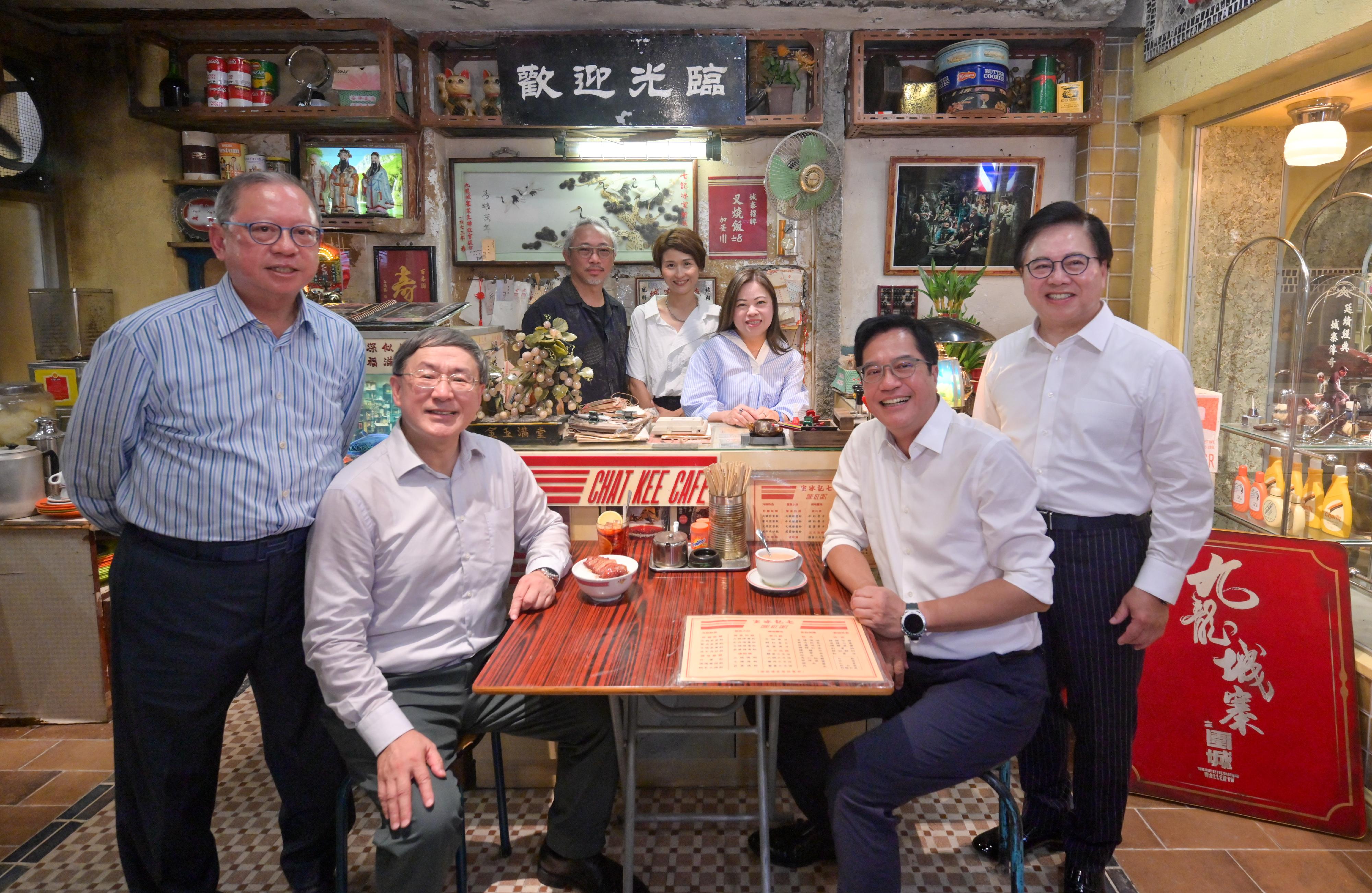 The opening ceremony of the "Kowloon Walled City: A Cinematic Journey" Movie Set Exhibition was held at Kowloon Walled City Park today (May 23). Photo shows the Art Director of the film, "Twilight of the Warriors: Walled In", Mr Ken Mak (back row, left), and the curator of the exhibition, Ms Renee Wong (back row, centre), giving a guided tour to the Deputy Chief Secretary for Administration, Mr Cheuk Wing-hing (front row, second left); the Deputy Financial Secretary, Mr Michael Wong (front row, second right); the Secretary for Culture, Sports and Tourism, Miss Rosanna Law (back row, right); the Chairman of the Hong Kong Film Development Council, Dr Wilfred Wong (front row, first right); and the Chairman of the Hong Kong Tourism Board, Dr Peter Lam (front row, first left).