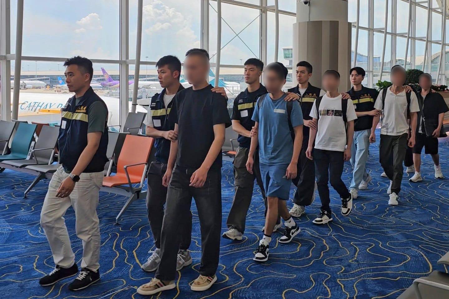 The Immigration Department (ImmD) carried out a repatriation operation today (May 23). A total of 18 Vietnamese illegal immigrants and overstayers were repatriated to Vietnam. Photo shows removees being escorted by ImmD officers to depart from Hong Kong.