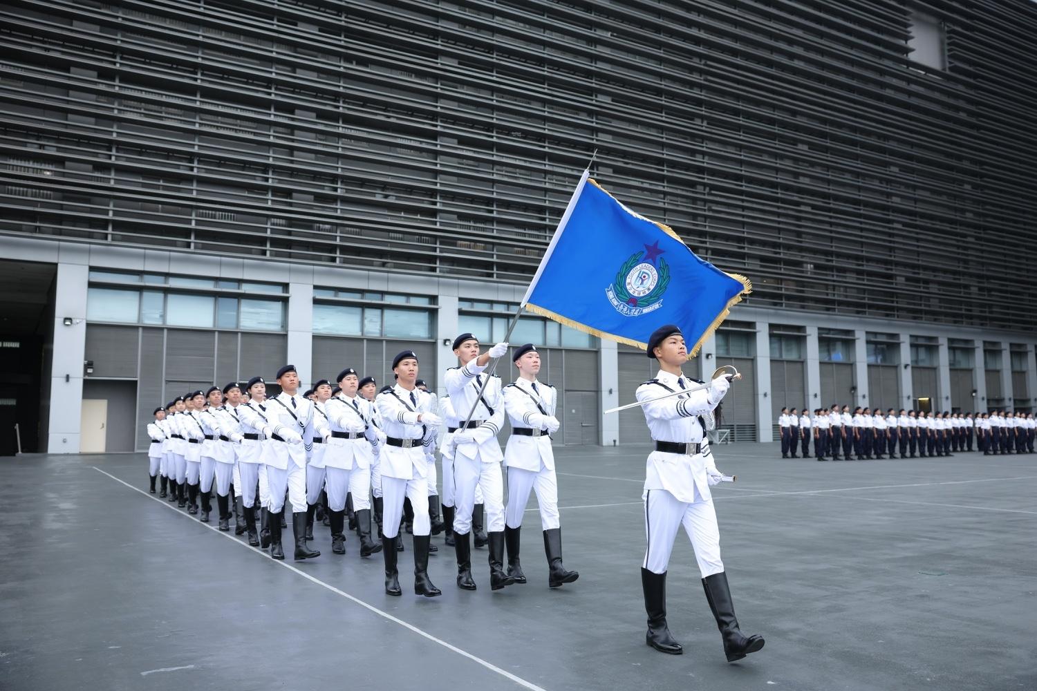 The Immigration Department held the Grand Immigration Department Youth Leaders Corps (IDYL) Parade cum Promotion Ceremony 2025 at the Immigration Service Institute of Training and Development in Tuen Mun today (May 25). Photo shows the Flag Party, comprised of IDYL Guard of Honour, debuting their brand-new uniform and marching in with the IDYL flag.

