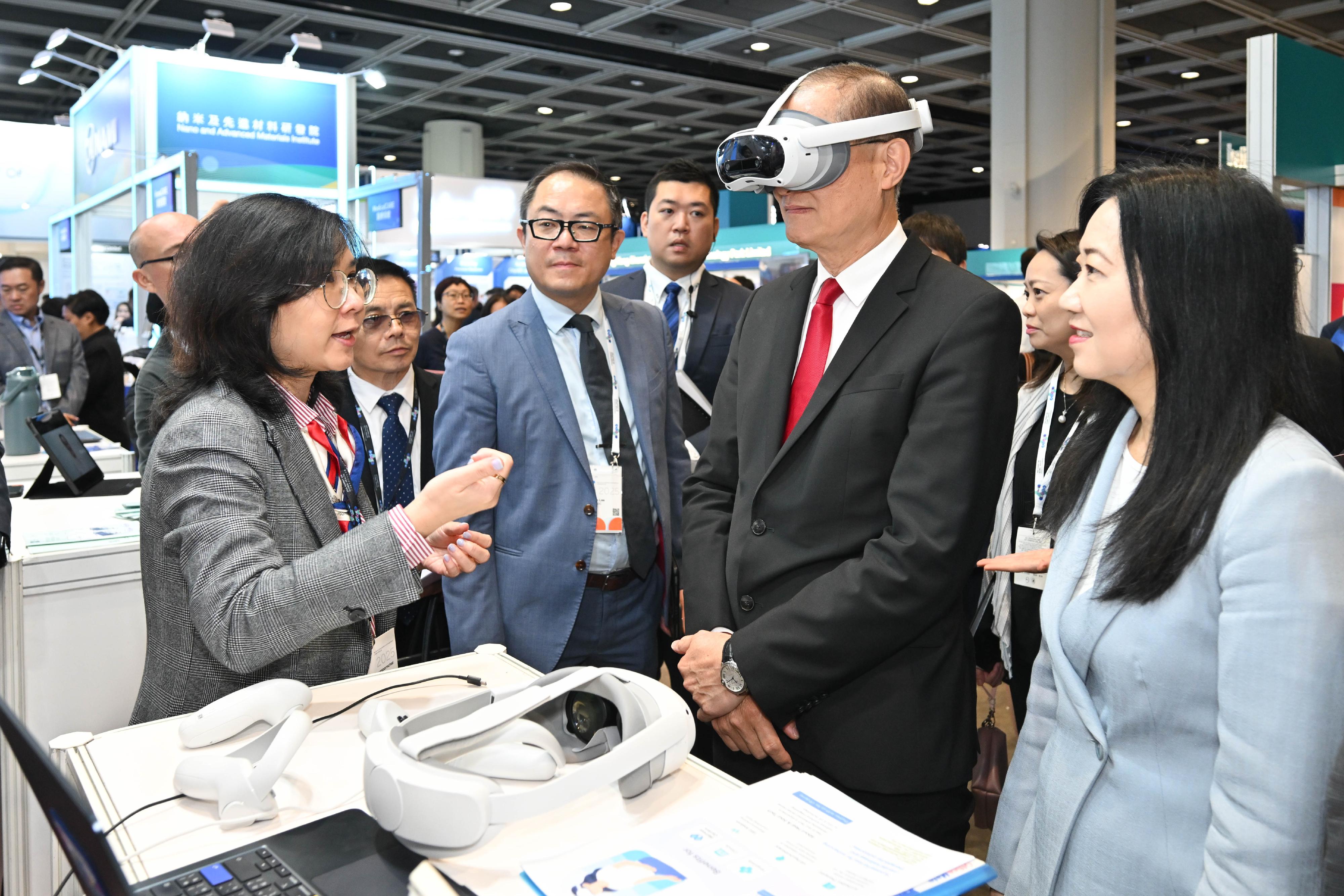 The Secretary for Health, Professor Lo Chung-mau (second right), tours an exhibition booth set up at the Asia Summit on Global Health today (May 26).