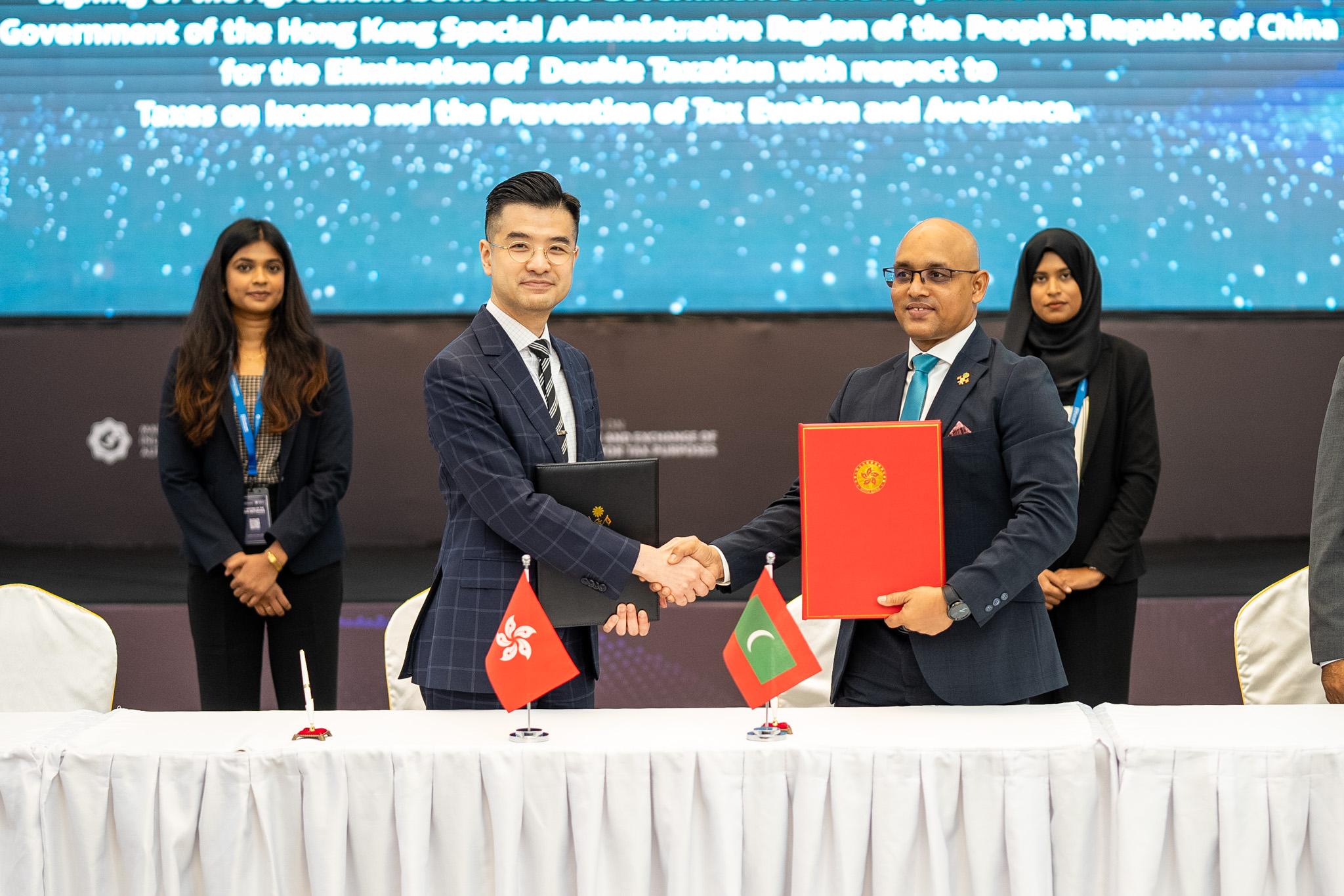The Commissioner of Inland Revenue, Mr Benjamin Chan (left), exchanges documents with the Commissioner General of Taxation of the Maldives Inland Revenue Authority, Mr Hassan Zareer, after signing a comprehensive avoidance of double taxation agreement today (May 26, Maldives time).