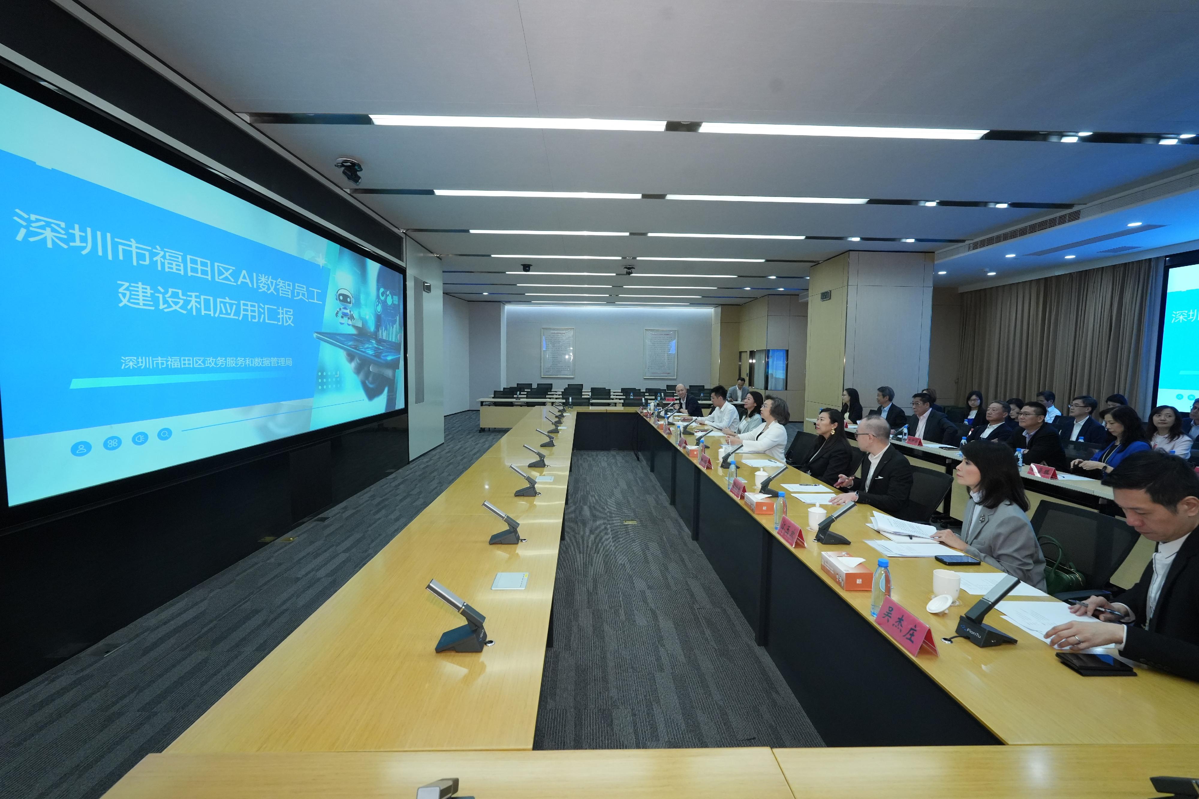The Secretary for the Civil Service, Mrs Ingrid Yeung, led officials from the Civil Service Bureau and the Digital Policy Office on a duty visit to Shenzhen together with the delegation of  the Legislative Council (LegCo) Panel on Public Service today (May 26). They went to learn about the use of AI by relevant local organisations there to assist in handling government administrative work. Photo shows Mrs Yeung (first row, fourth left), the Deputy Director of the Hong Kong and Macao Affairs Office of Shenzhen, Ms Li Lirong (first row, third left), and LegCo members being briefed on the "AI digital employees" at the Government Services and Data Management Bureau of the Shenzhen Municipality in Futian District.