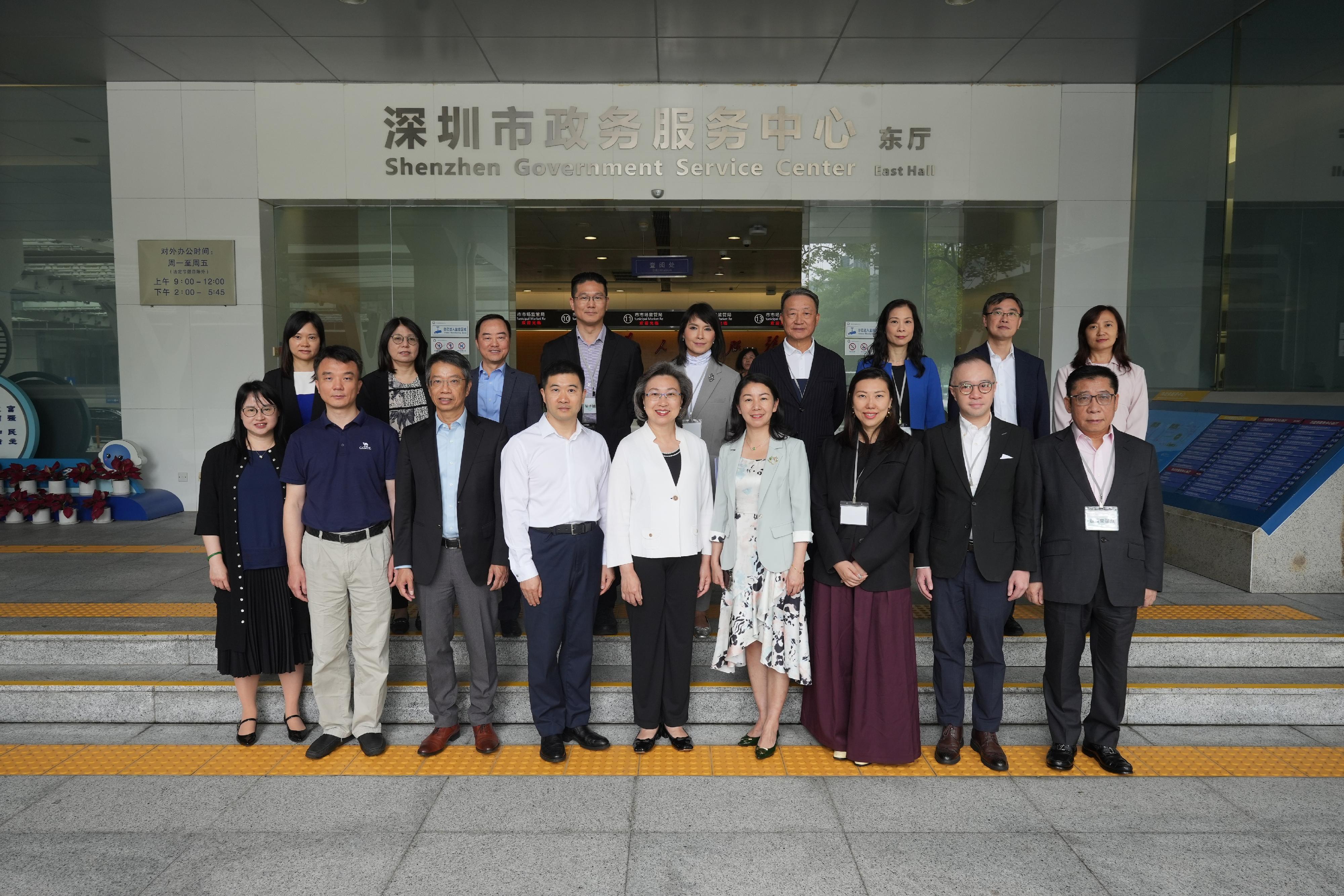The Secretary for the Civil Service, Mrs Ingrid Yeung, led officials from the Civil Service Bureau and the Digital Policy Office on a duty visit to Shenzhen together with the delegation of the Legislative Council (LegCo) Panel on Public Service today (May 26). They went to learn about the use of AI by relevant local organisations there to assist in handling government administrative work. Mrs Yeung (front row, centre); the Deputy Director of the Hong Kong and Macao Affairs Office of Shenzhen, Ms Li Lirong (front row, fourth right); the Permanent Secretary for the Civil Service, Mr Clement Leung (front row, third left); and the Commissioner for Digital Policy, Mr Tony Wong (back row, third left), are pictured with LegCo members at the Shenzhen Government Service Center.