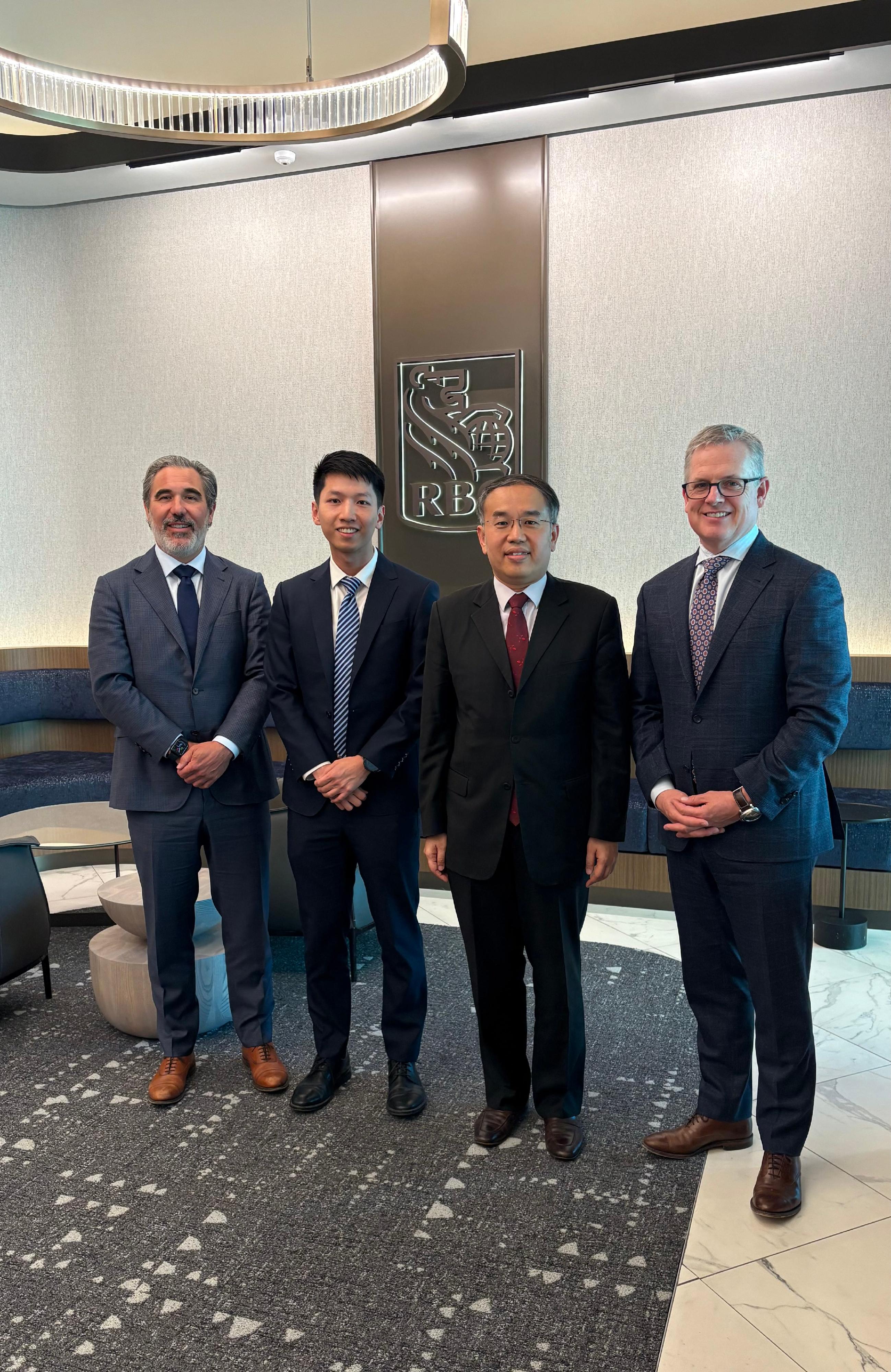 The Secretary for Financial Services and the Treasury, Mr Christopher Hui, started his five-day visit to Canada on May 26 (Toronto Time), with his first stop being Toronto. Photo shows Mr Hui (second right) with the Group Head, RBC Wealth Management, Mr Neil McLaughlin (first right), of the Royal Bank of Canada, and its Executive Vice President and Global Head, Strategy, Products and Digital Investing, Mr Stuart Rutledge (first left), after their meeting. Next to Mr Hui is the Acting Director, Hong Kong Economic and Trade Office (Toronto), Mr Gavin Yeung (second left).

