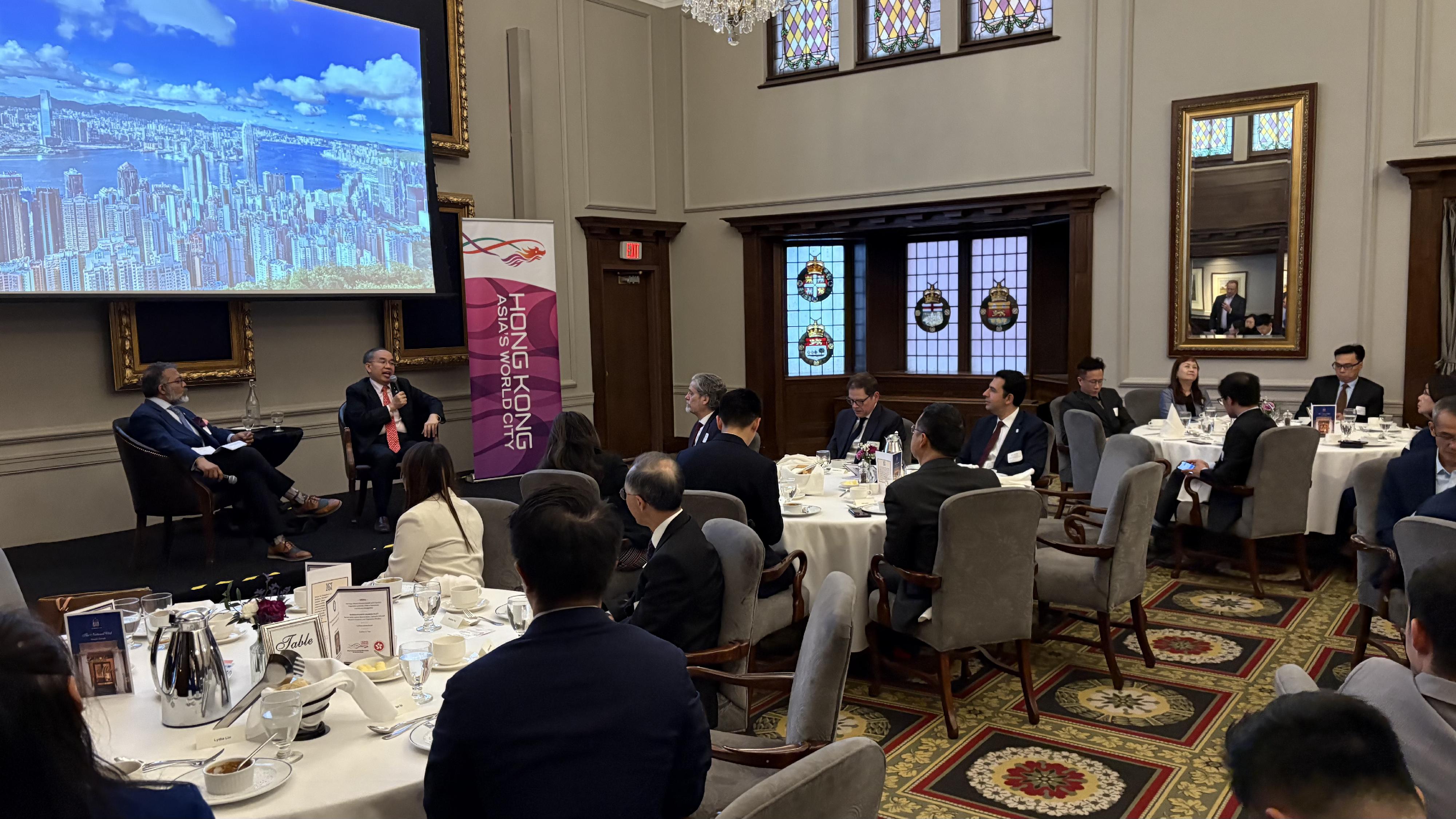 The Secretary for Financial Services and the Treasury, Mr Christopher Hui (right on stage), engaged in a fireside chat with the President of the National Club, Mr Arnie Guha (left on stage), at a business luncheon with financial leaders in Toronto, Canada, on May 27 (Toronto Time). The luncheon was co-organised by the Hong Kong Economic and Trade Office (Toronto), Invest Hong Kong (Canada) and the National Club.