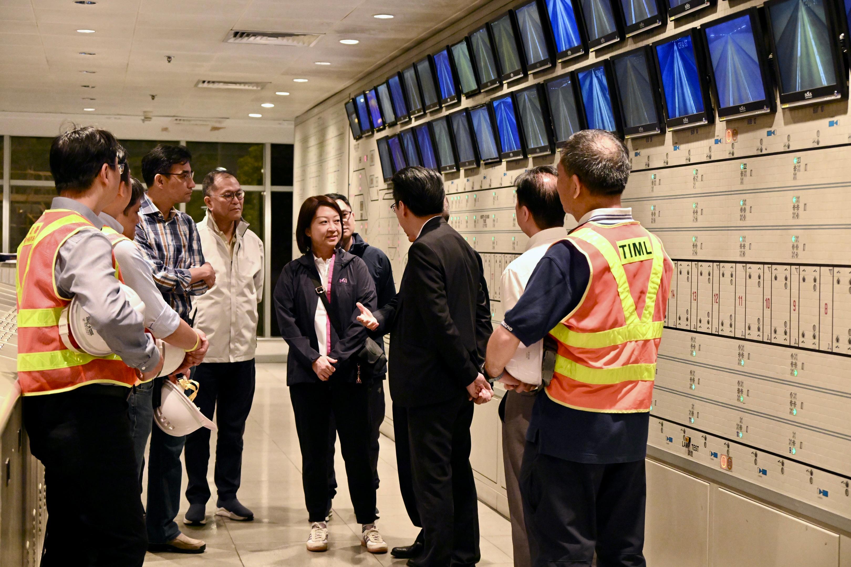 The Government took over the Tai Lam Tunnel (TLT) at 0.00am today (May 31), and implemented the new tolls and the HKeToll. The Commissioner for Transport, Ms Angela Lee, visited the TLT Administration Building in the small hours to ensure a safe and smooth takeover. Photo shows Ms Lee (fourth right) being briefed by the operator on the switchover works conducted during its full closure.