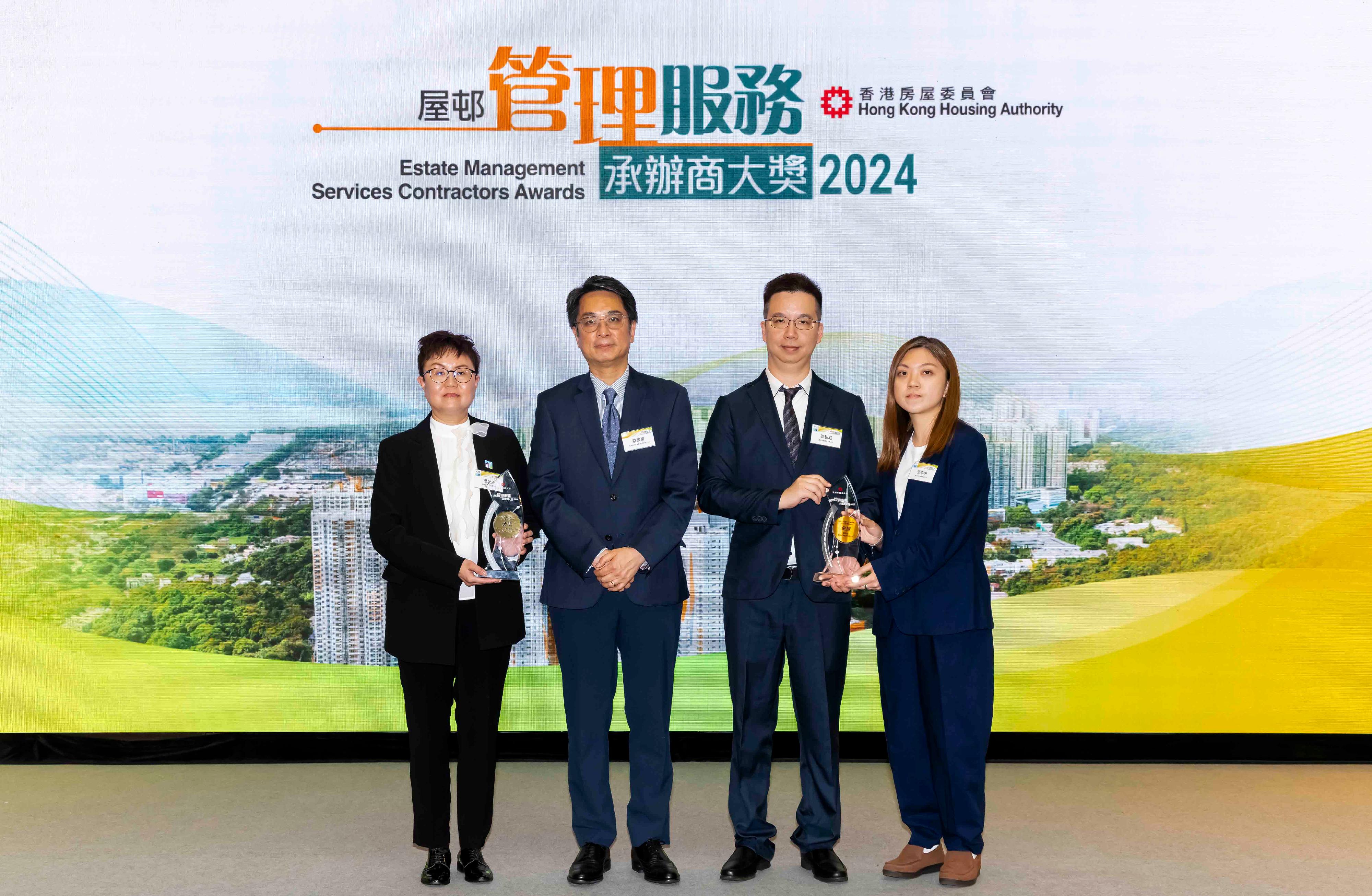 The Hong Kong Housing Authority hosted the Estate Management Services Contractors Awards 2024 presentation ceremony at Domain in Yau Tong today (June 10). Photo shows the Assistant Director of Housing (Estate Management)(2), Mr Yim Ka-ho (second left), with the representatives of the winners of the Best Public Rental Housing Estate (Property Services) Large Estate Awards and Best Public Rental Housing Estate (Property Services) Small Estate Award.