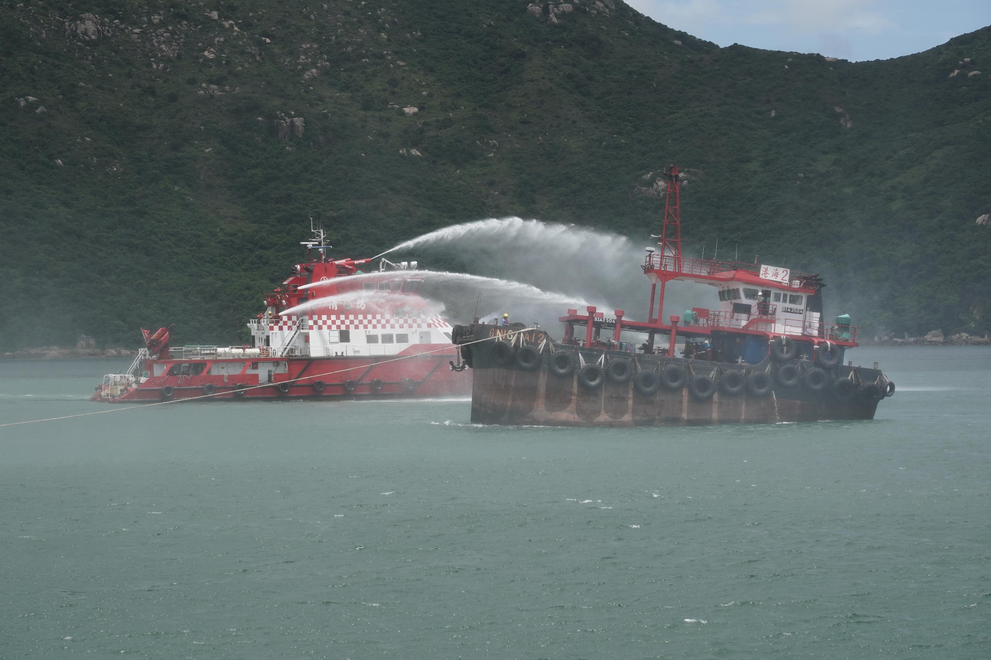 The Marine Department, in collaboration with the search and rescue (SAR) agencies in Guangdong and Macao as well as several Hong Kong government departments, smoothly conducted a joint maritime SAR exercise in the waters off Ha Mei Wan, Lamma Island, today (June 11). Photo shows a participating SAR agency putting out the fire on an oil tanker.